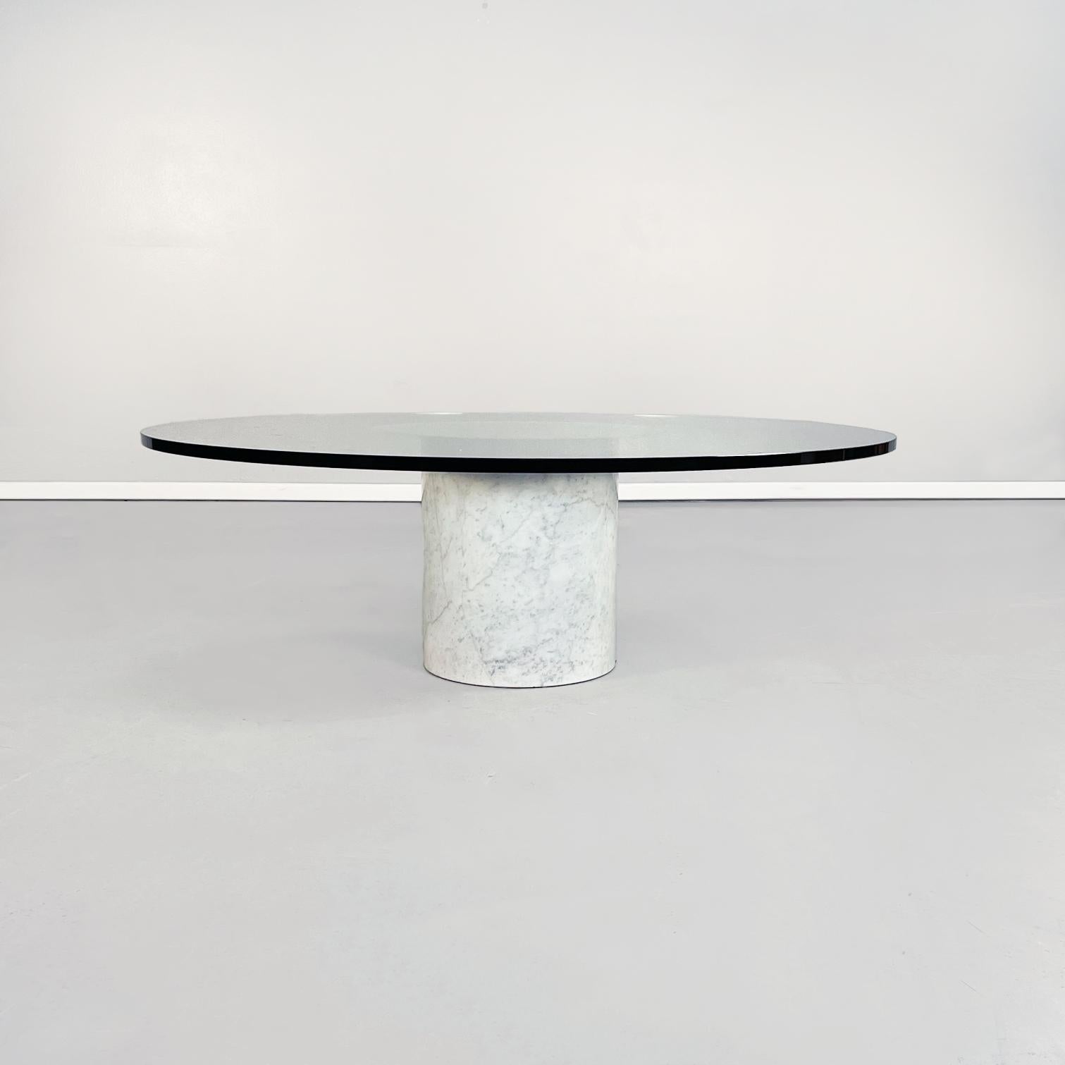 Italian mid-century Round coffee table in aquamarine glass and white marble, 1980s
Round glass coffee table with cylindrical marble base. The round piano in thick aquamarine glass has in the center a round mirror. The cylindrical base is in white