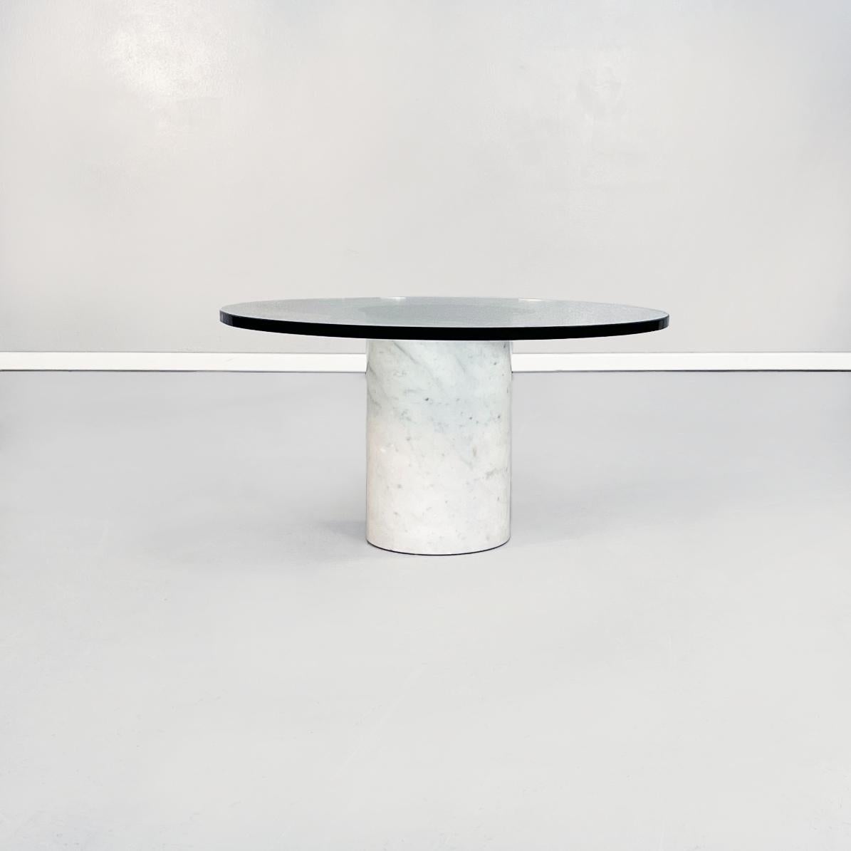 Italian mid-century round coffee table in aquamarine glass and white marble, 1980s
Round glass coffee table with cylindrical marble base. The round piano in thick aquamarine glass has in the center a round mirror. The cylindrical base is in white