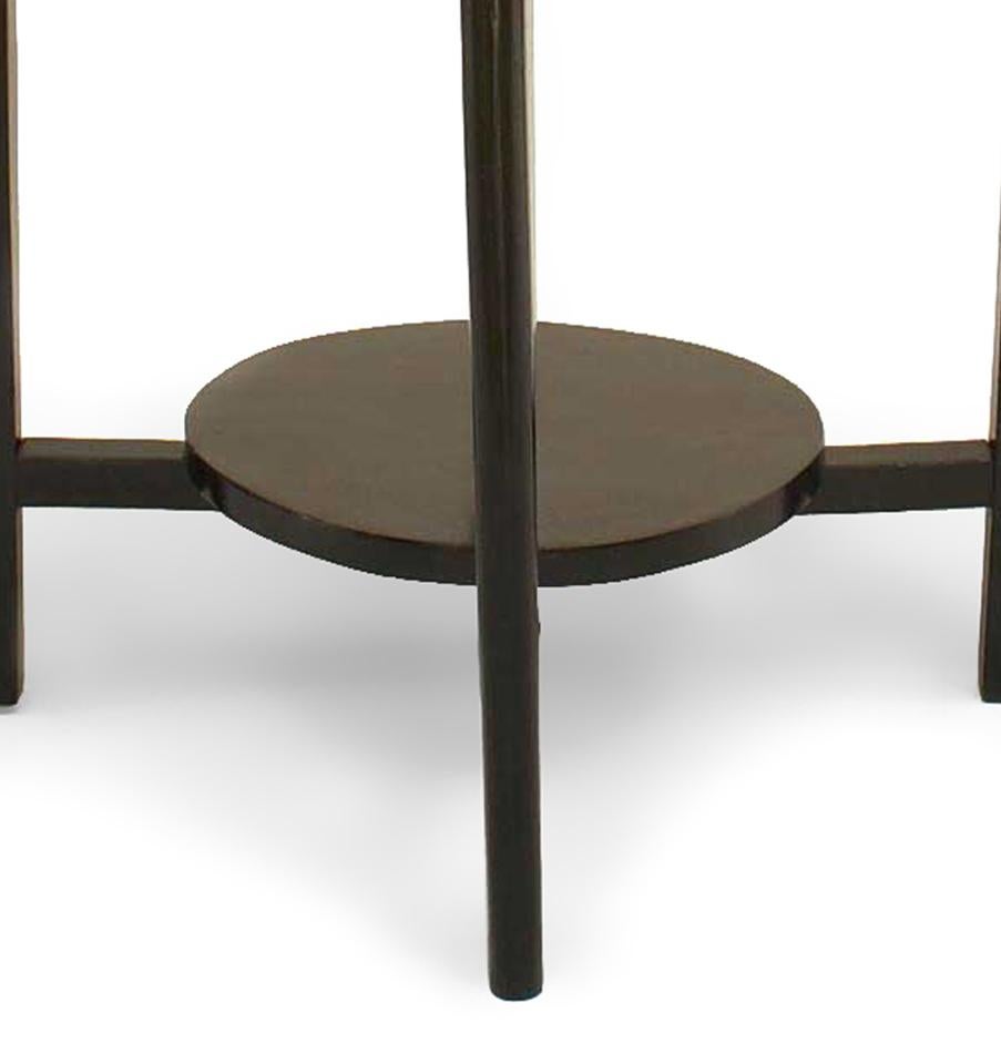 Italian Mid-Century (1940s) ebonized round coffee table with a smaller round shelf supported by a stretcher and four tapered legs.

Top has been touched up, not pristine.