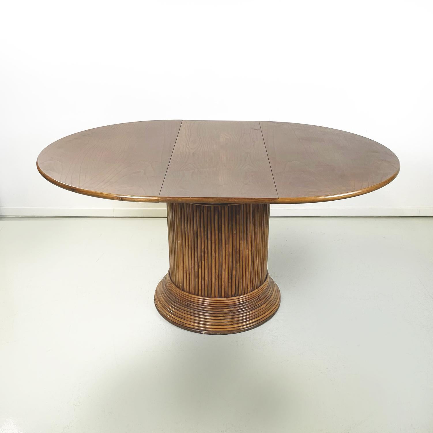 Italian mid-century Round or oval wooden dining table with extensions, 1960s
Dining table with extensions, in wood. The top can be round or, adding the central extension, oval. The round base is in bamboo slats.
1960s.
Good general condition, it has