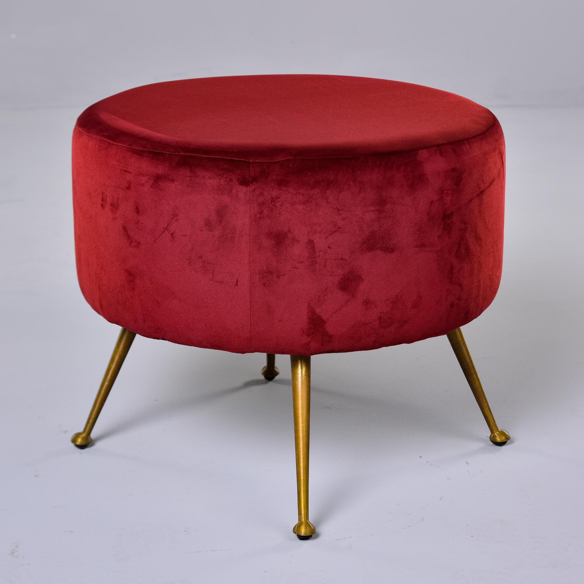 Found in Italy, this stool dates from the 1950s. Round seat with dark red upholstery and four slender, tapered brass legs with rounded feet. Unknown maker. Very good overall vintage condition. We acquired as shown from an Italian dealer - the