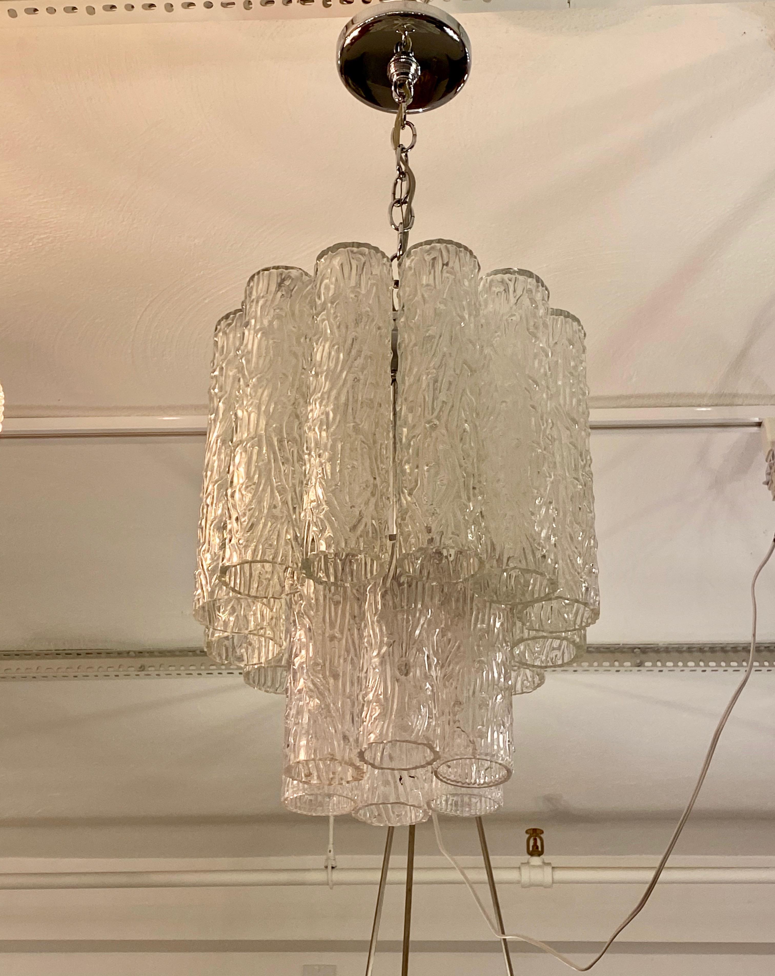 Midcentury two-tiered round chandelier. Consisting of tronchi cylindrical glass pieces. The glass Tronchi hangs from a nickel (silver) frame as pictured. Any amount of chain can be added for custom hanging length. Has been rewired for American use
