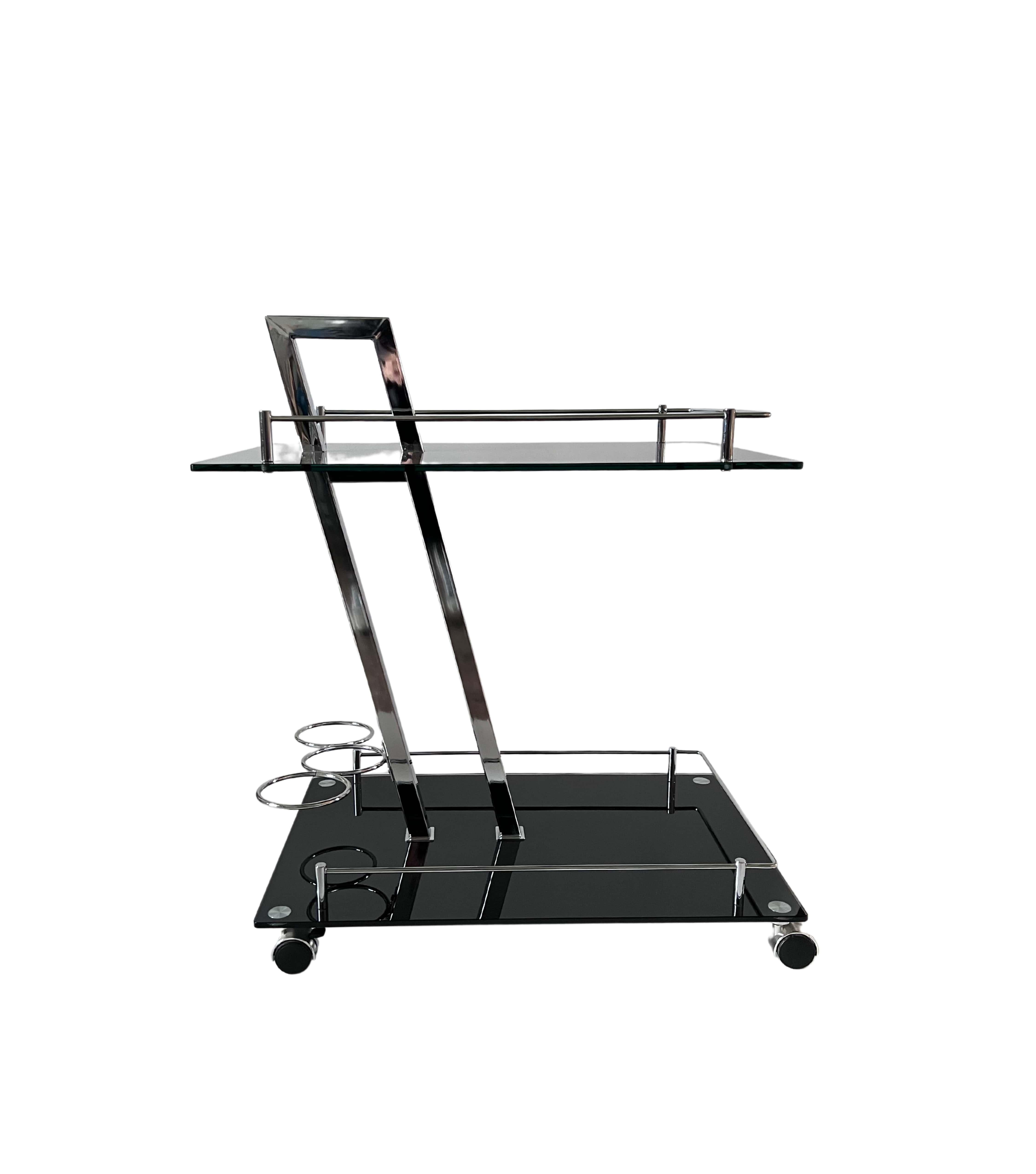 This stunning bar cart features black glass shelves set on a chrome frame, showcasing a unique and stylish design. In pristine condition, this piece exudes both elegance and durability, making it the perfect addition to any home or entertainment