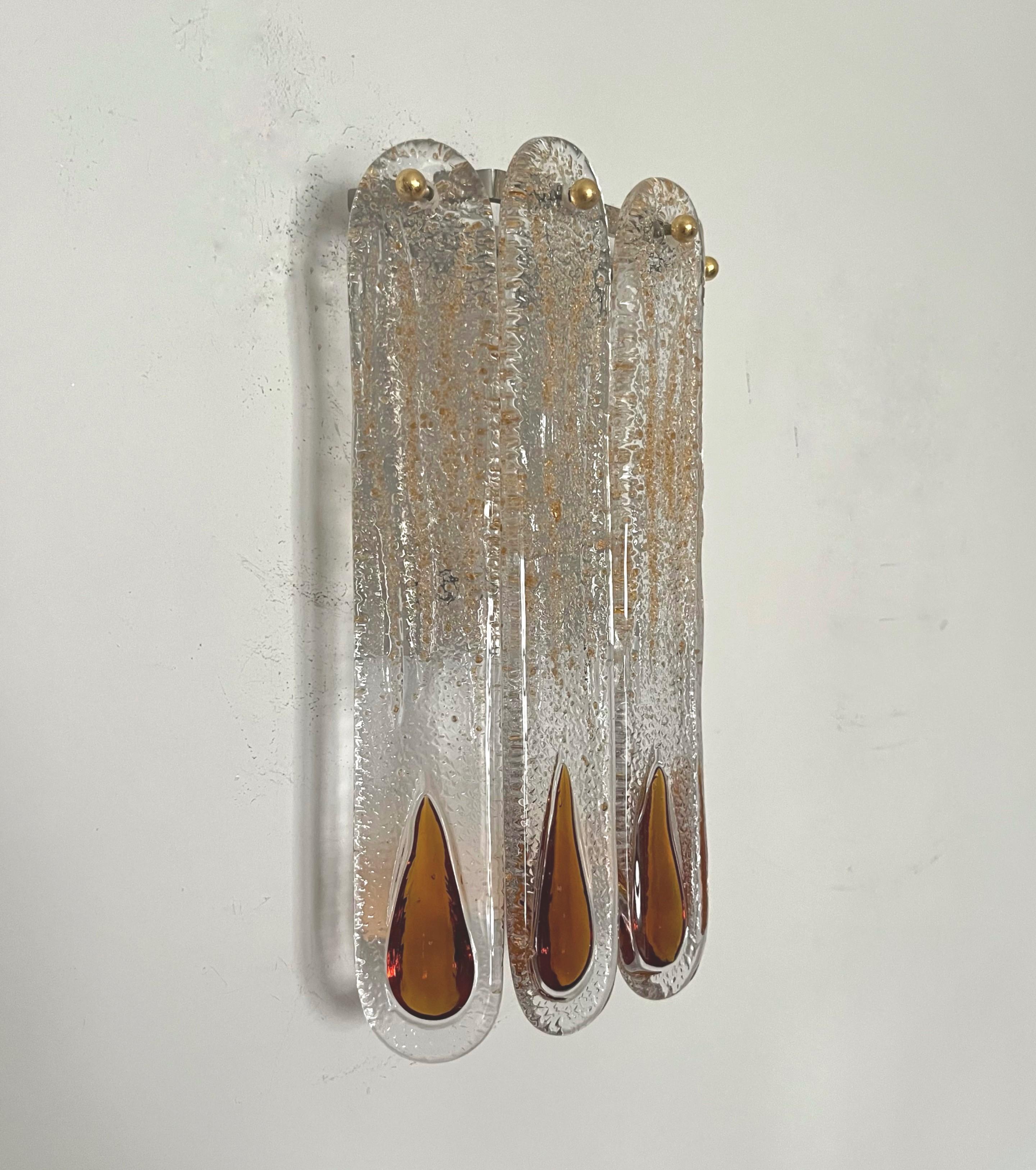Gorgeous and lovely set of four Italian Murano glass wall sconces from 1970s. These fixtures were made during the 1970s in Italy by Mazzega.
Each sconce is equipped with 2 light sockets E14. A professional electrician has checked and prepared the