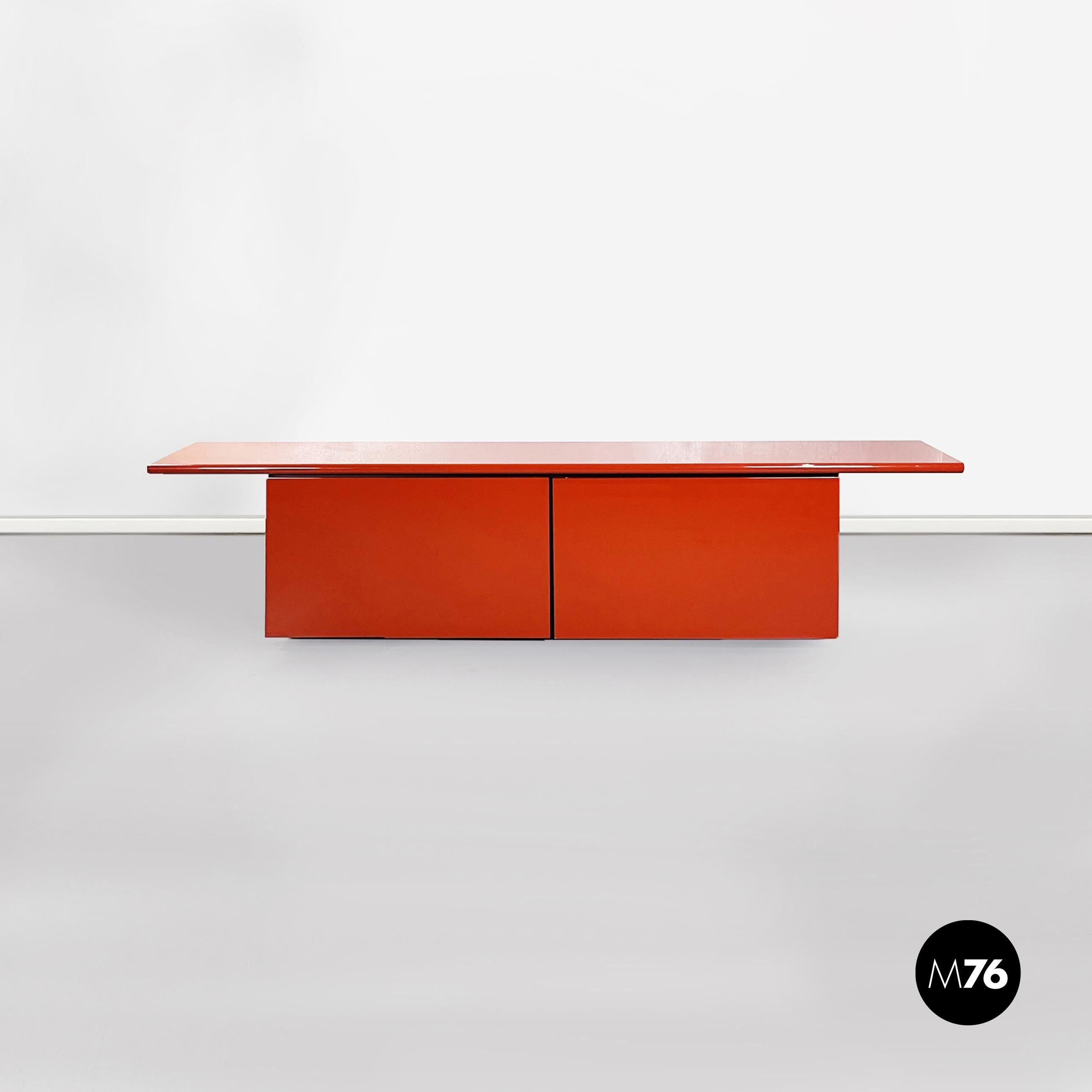 Italian mid-century Sheraton sideboard by Stoppino and Acerbis for Acerbis, 1980s.
Sheraton sideboard in light red lacquered solid wood with protruding rectangular top. Swing door with 4 drawers and 3 compartments inside with original aquamarine