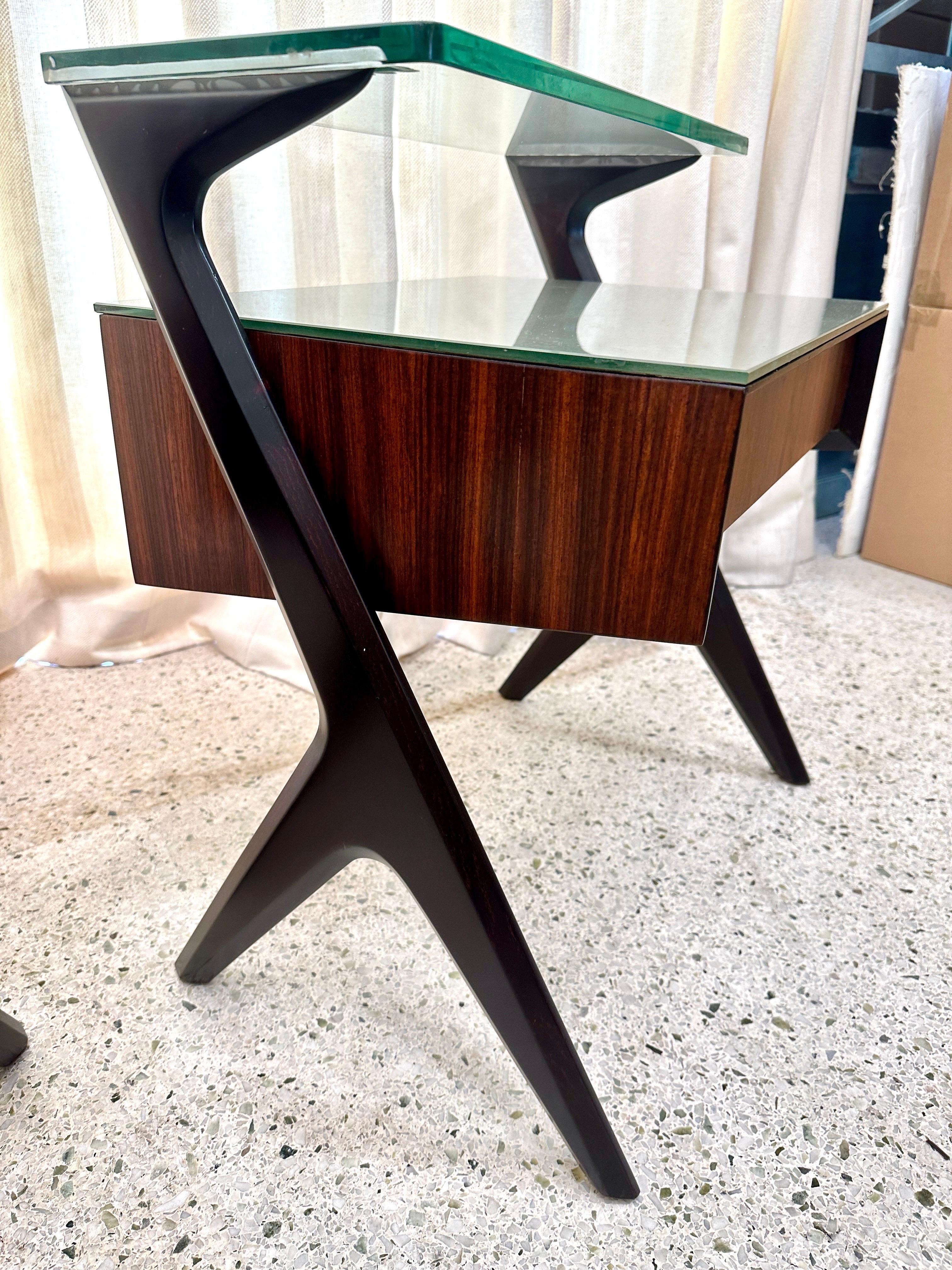 Superbes tables d'appoint ou tables de nuit conçues par Vittorio & Plinio Dassi dans les années 1950. Son caractère esthétique unique est dû à la forme sculpturale originale des tiroirs et des supports latéraux, ainsi qu'au plateau en verre gris