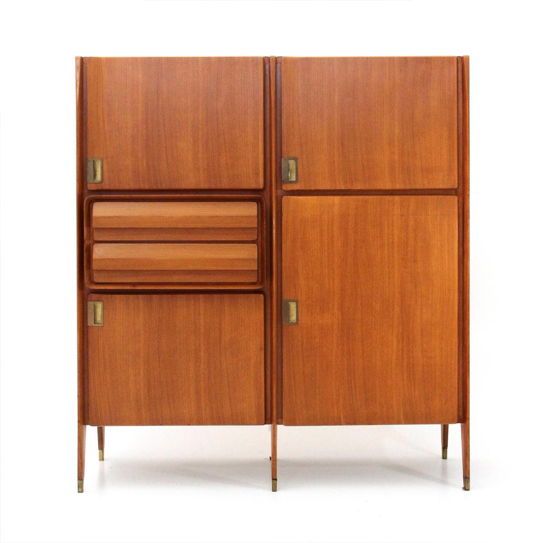 Sideboard produced in the 1950s by Consorzio Esposizione Mobili Cantù.
Wood veneered uprights with tapered front edges and brass feet.
Wood veneer storage compartments with door closure, brass handle and glass shelves.
Two drawers with solid wood