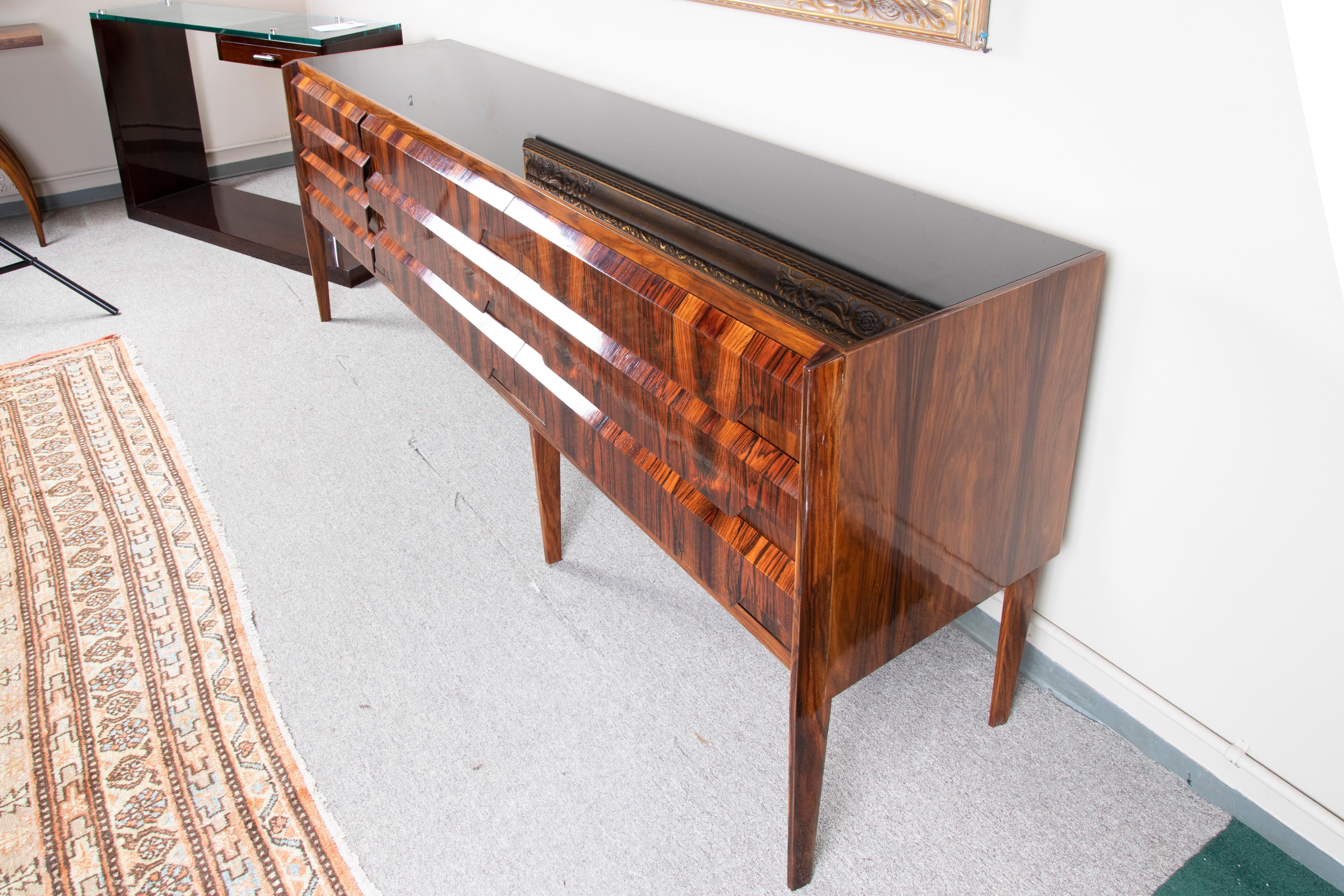 Beautiful sideboard made out of fine walnut wood. Resting on 6 slim legs. Sideboard has multiple keyless drawers and lots of storage space. Top of the sideboard is covered with glass. 

 Italy, c. 1950s
 Condition is perfect. Restored.