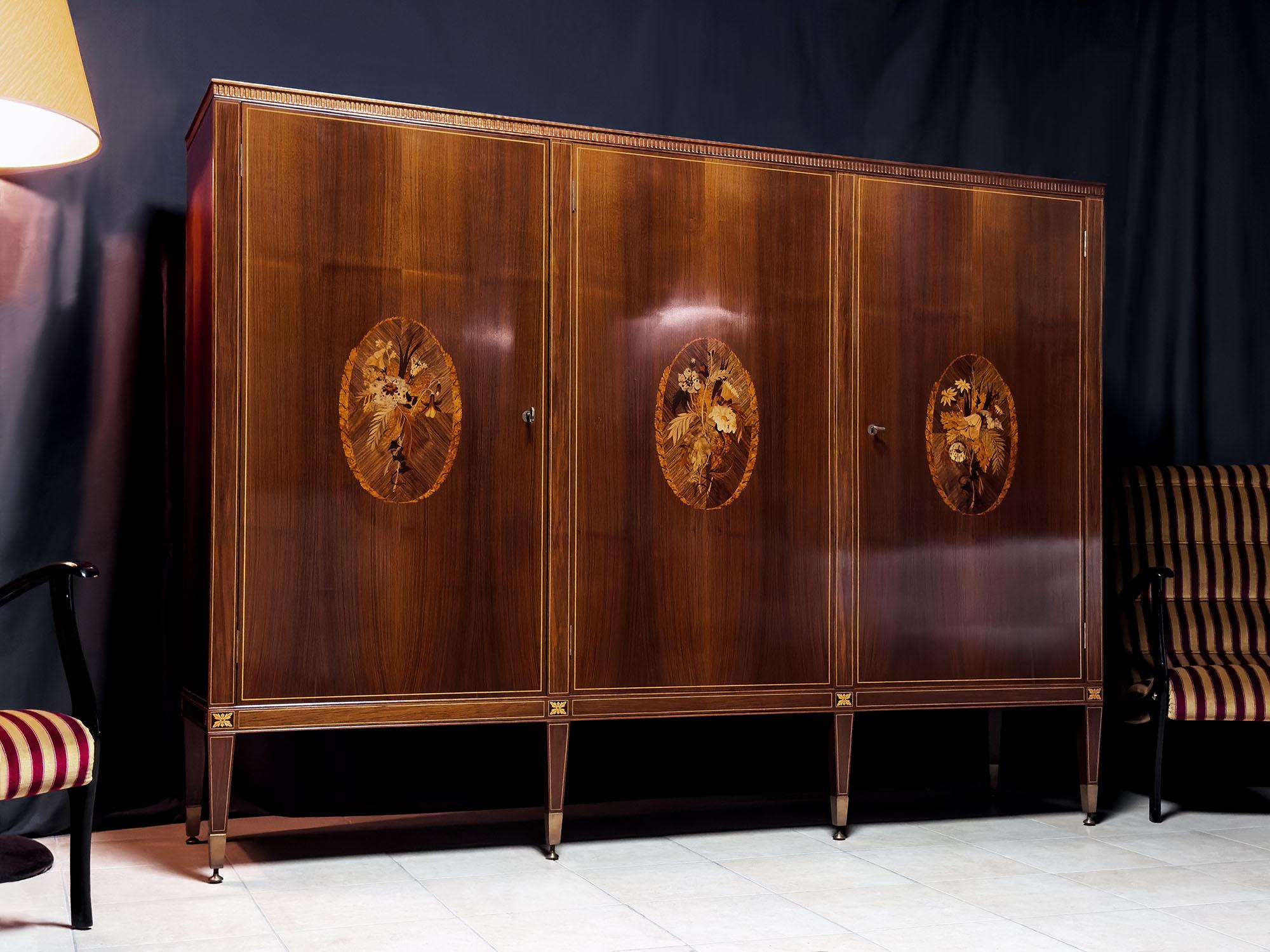Presenting this stunning Italian sideboard with a bar compartment, crafted in the 1950s by Marelli & Colico and so well designed by professor and architect Paolo Maggi.

Its standout feature lies in the three doors adorned with breathtaking inlays