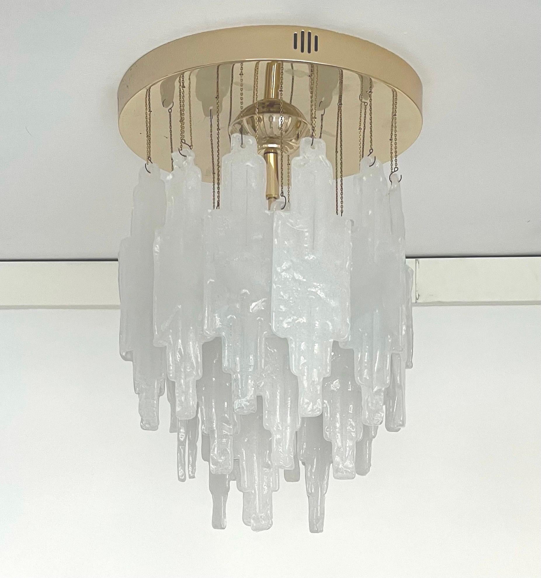 Beauty and stunning snow white colorMurano glass Chandelier by Poliarte. This Chandelier was designed and manufactured during the 1970s in Italy. 
This Chandelier is composed by 28 units of Murano glasses and brass structure. One more Murano glass