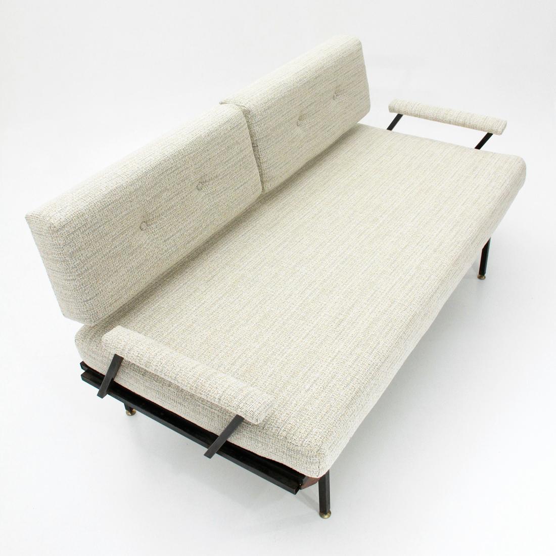 Italian manufacturing sofa bed produced in the 1950s.
Structure in black painted metal.
Solid wood strips.
Seat and back formed by padded cushions and lined with new fabric.
Height adjustable feet in brass.
Good general conditions, some signs