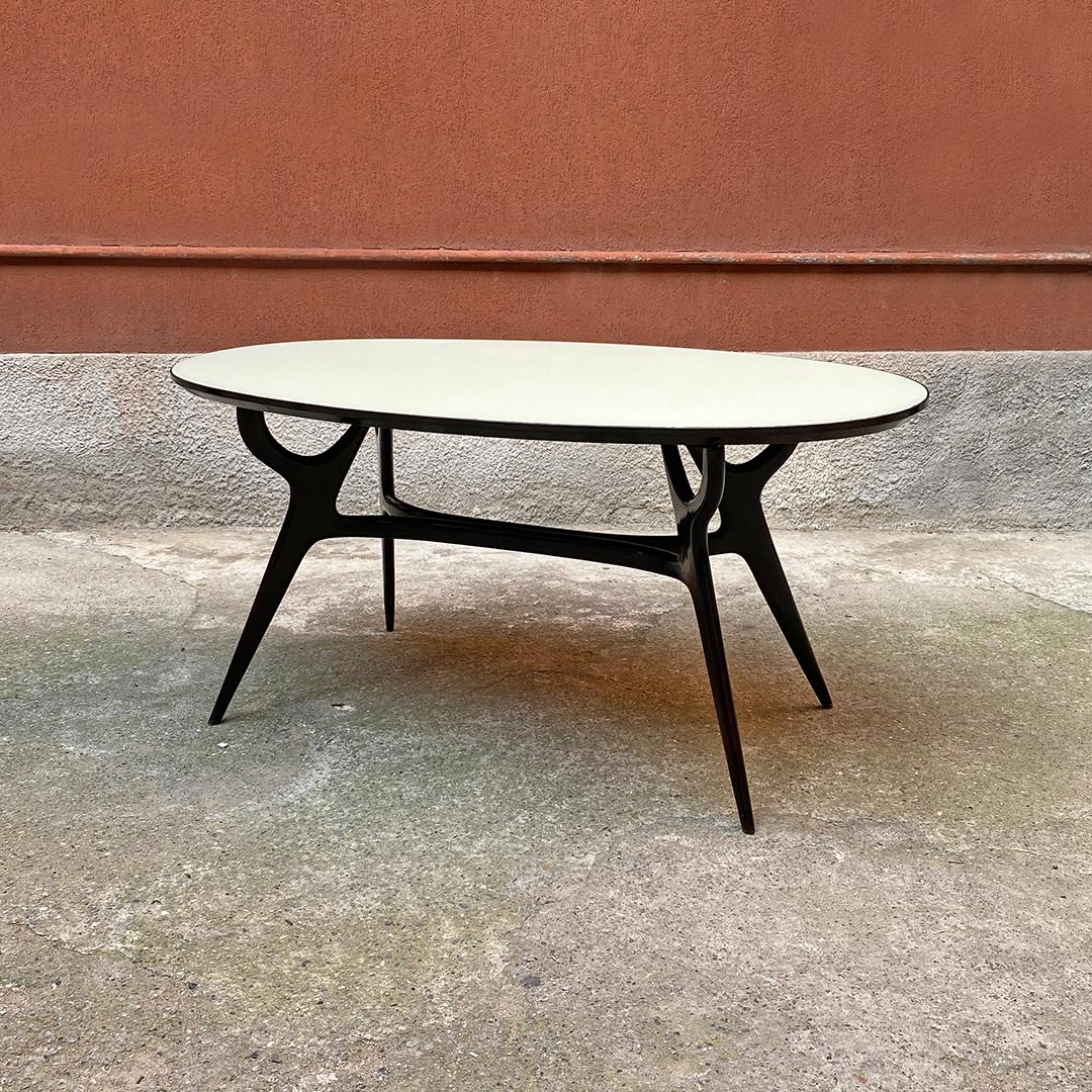 Italian mid century modern solid beech and glass top dining table by Ico Parisi, 1950s
Dining table with shaped structure in solid beech with dark color and glass top in pearl white painted back.
Designed by Ico Parisi in 1950s
Perfect condition,