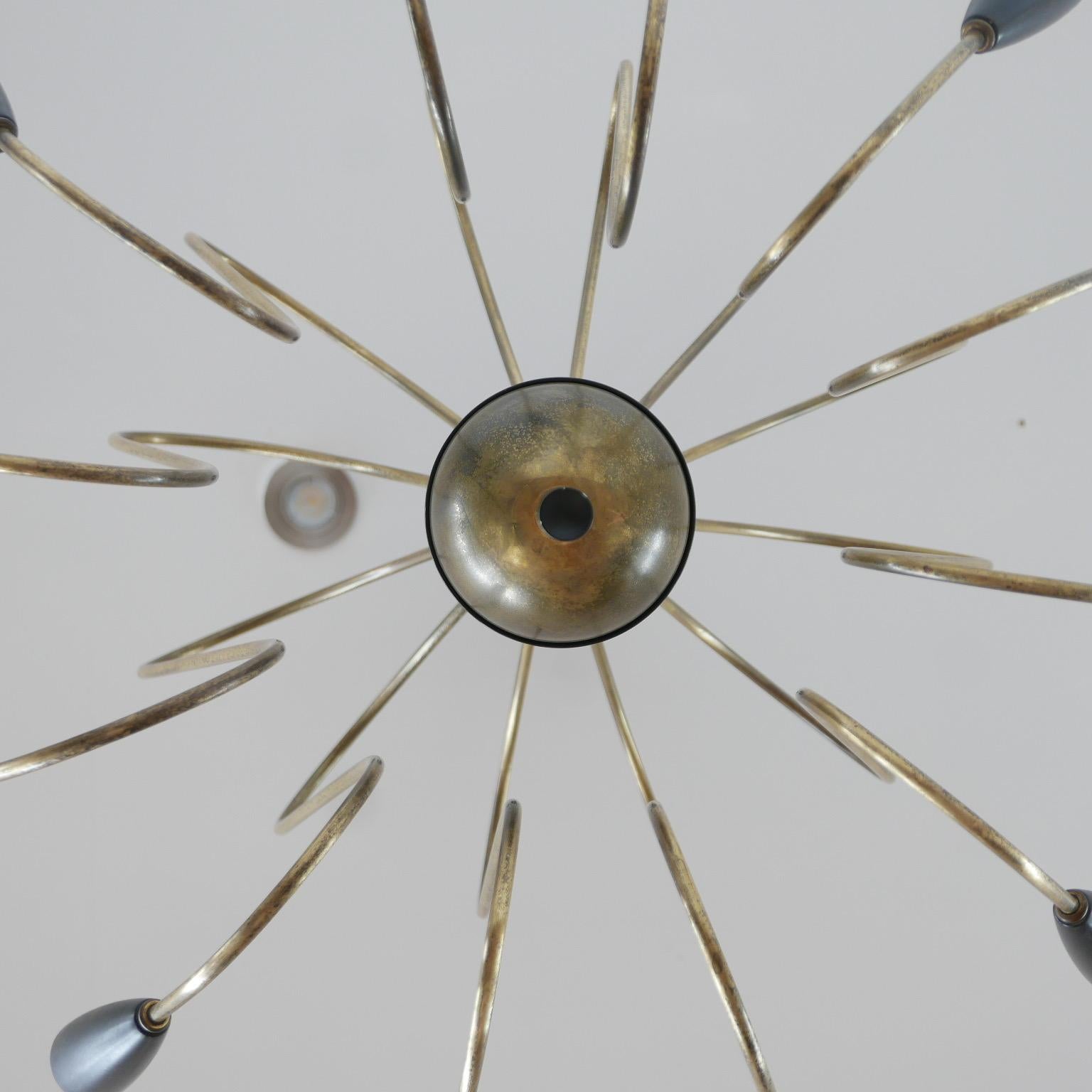 An Italian midcentury chandelier light.

Italy, circa 1960s.

Brass construction. Re-wired. 

In a rare dual curved shape almost octopus style. 

Dimensions: 70 diameter x 81 height in cm.
 