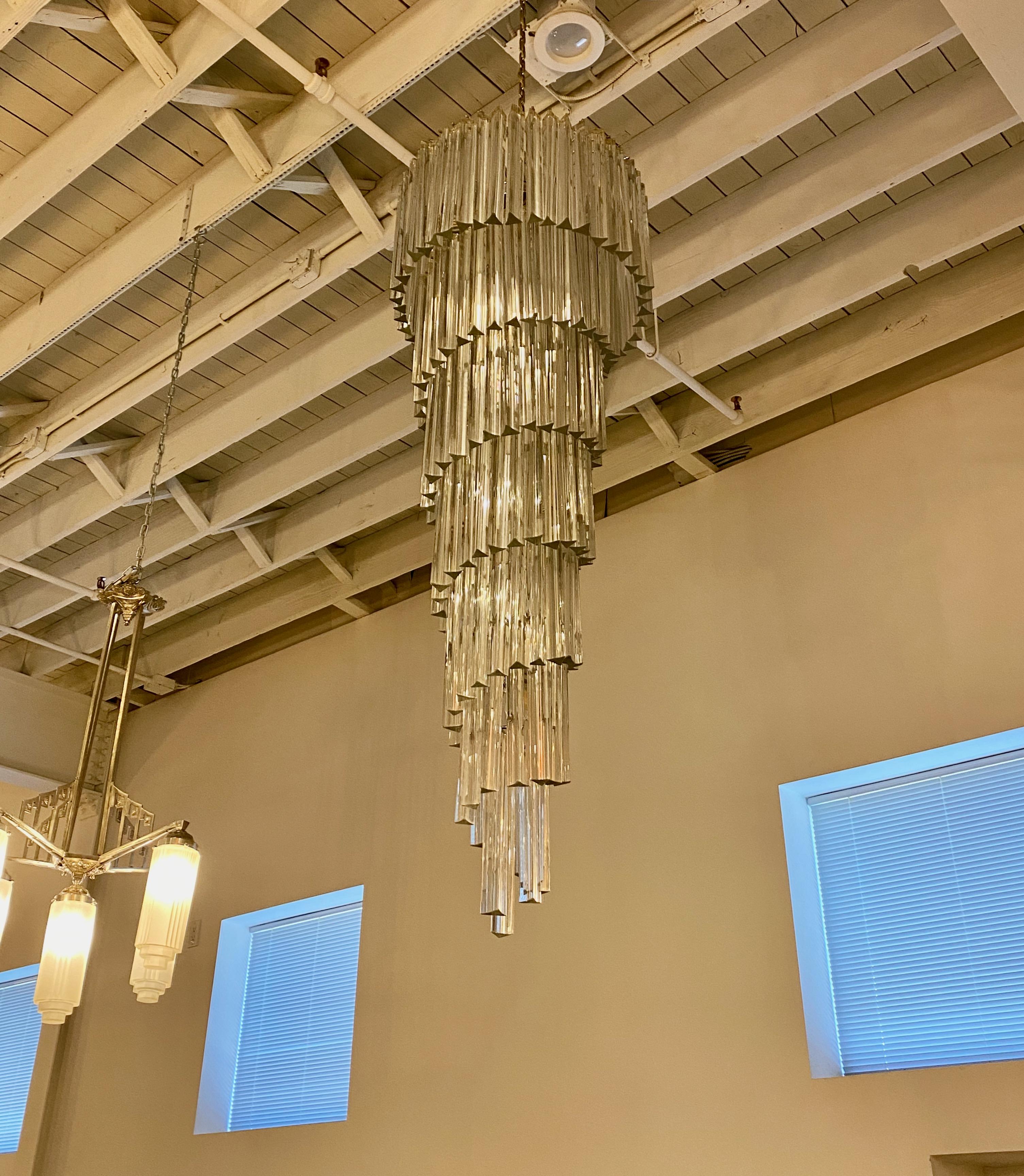 Stunning Mid-Century Modern Italian spiral chandelier. Each of the prisms are solid glass. They hang from hooks onto a spiral nickel (silver) frame, as pictured. Any amount of chain can be added for custom hanging length of the chandelier. Has been