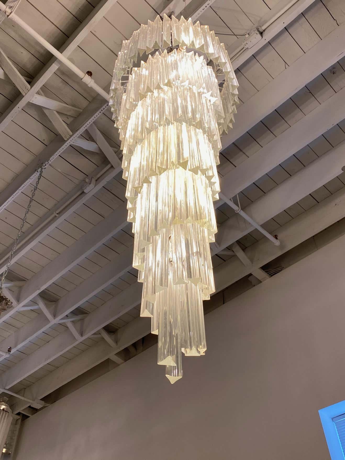 Stunning Mid-Century Modern Italian spiral chandelier. Each of the prisms are solid glass. They hang from hooks onto a spiral nickel (silver) frame, as pictured. Any amount of chain can be added for custom hanging length of the chandelier. Has been