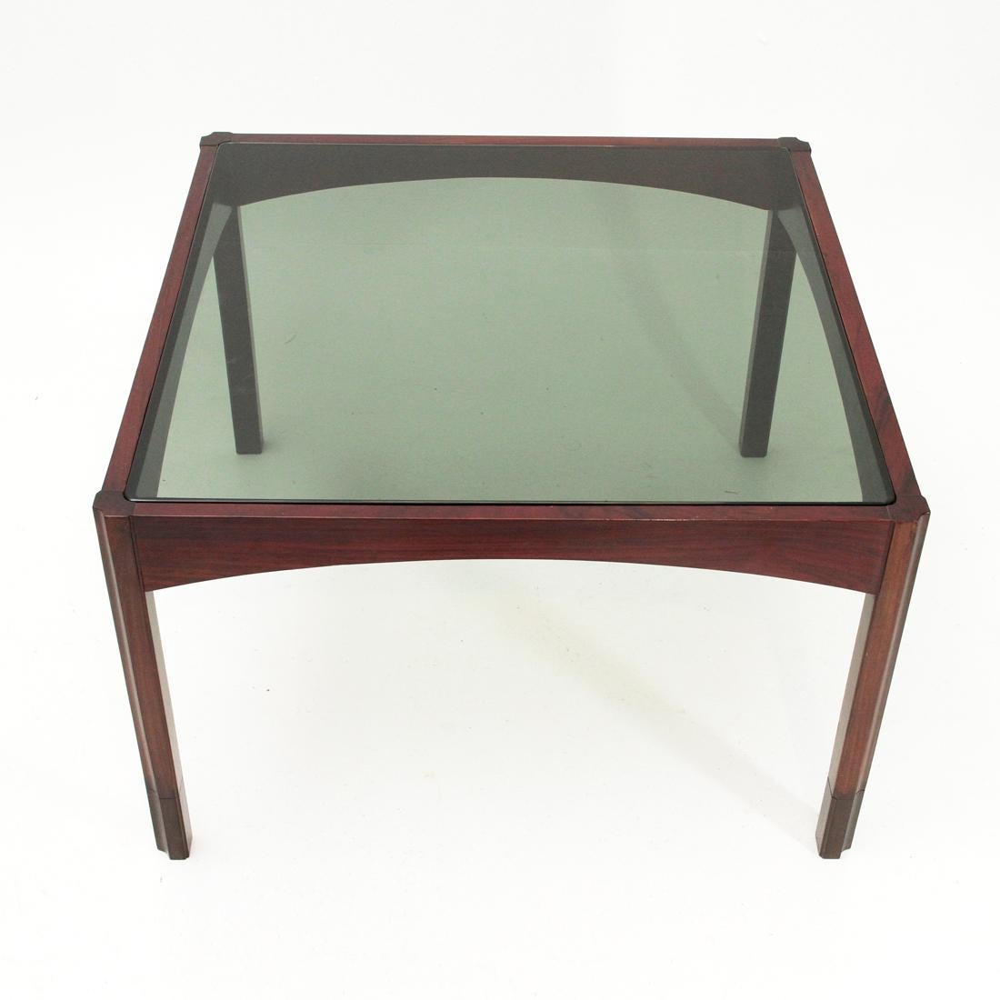 Italian manufacturing table produced in the 1960s. Solid wood frame.
Smoked glass top.
Legs in solid wood with side groove.
Good general conditions, some signs due to normal use over time.

Dimensions: Length 75 cm - depth 75 cm - height 48 cm.