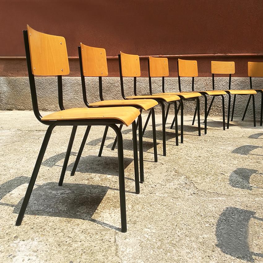 Set of 20 midcentury Italian chairs dating to the 1960s. Italian stackable chairs with metal structure and beechwood seat and backrest, coming from a school in Milan. This set preserve a really good condition and a lovable patina, in front of the