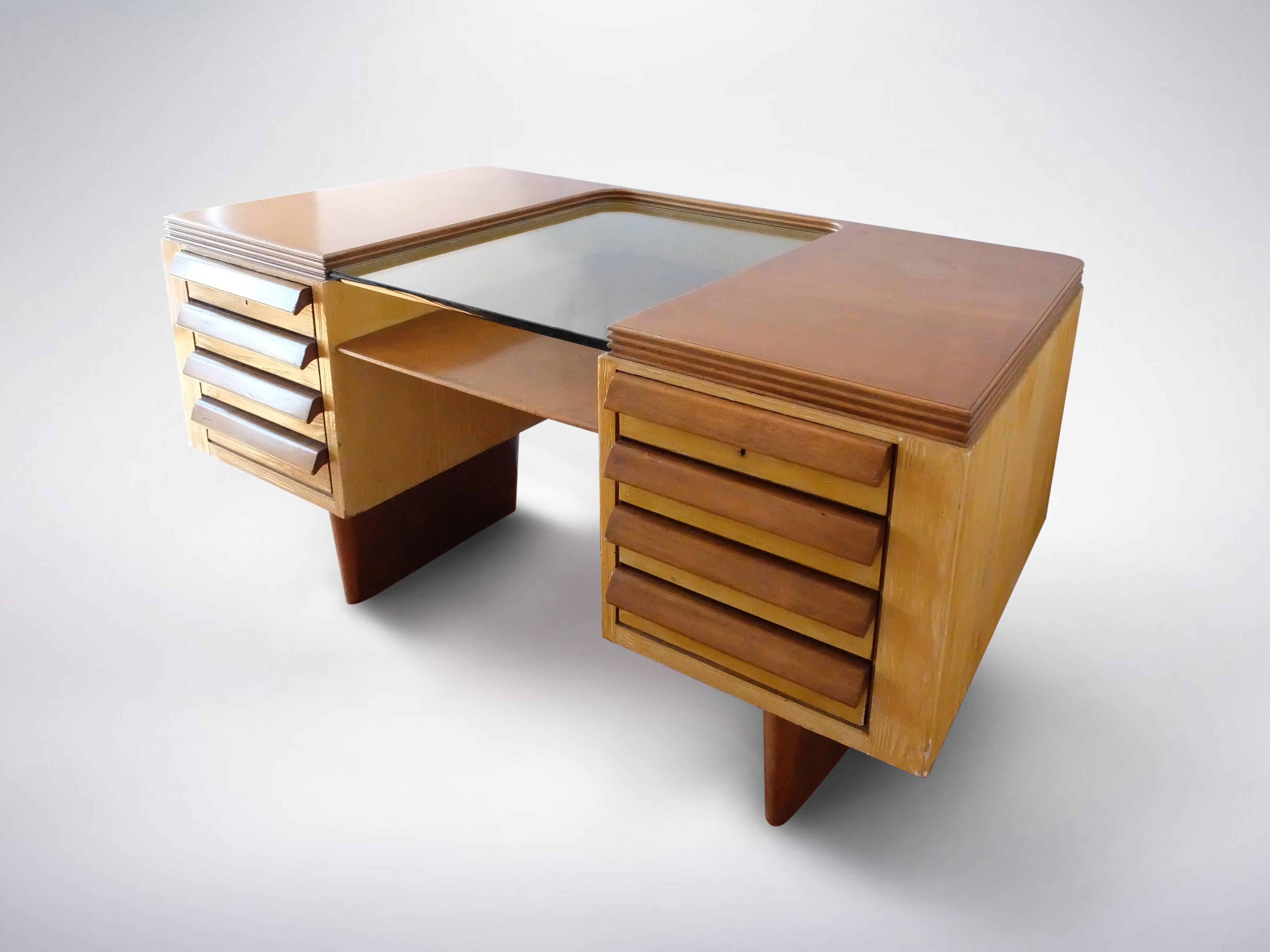 Italian mid-century stately wooden desk with glass top
1950s
Sturdy multipurpose desk with eight symmetrical drawers, on either side. The glass slab is in the middle giving the wooden table a surprising break, creating lightness.




Please
