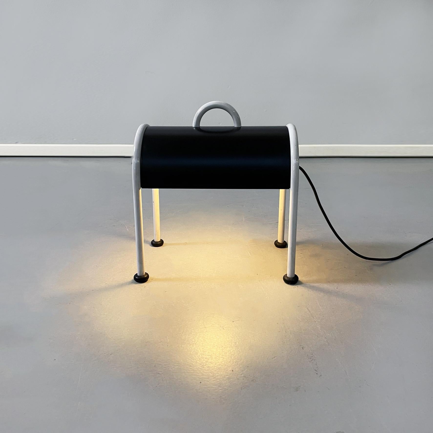 Italian mid-century steel Valigia floor or table lamp by Sottsass for Stilnovo, 1970s
Valigia table or floor lamp with tubular structure in white painted tubular steel. The sheet metal lampshade is bicolor, with opaque black exterior and white