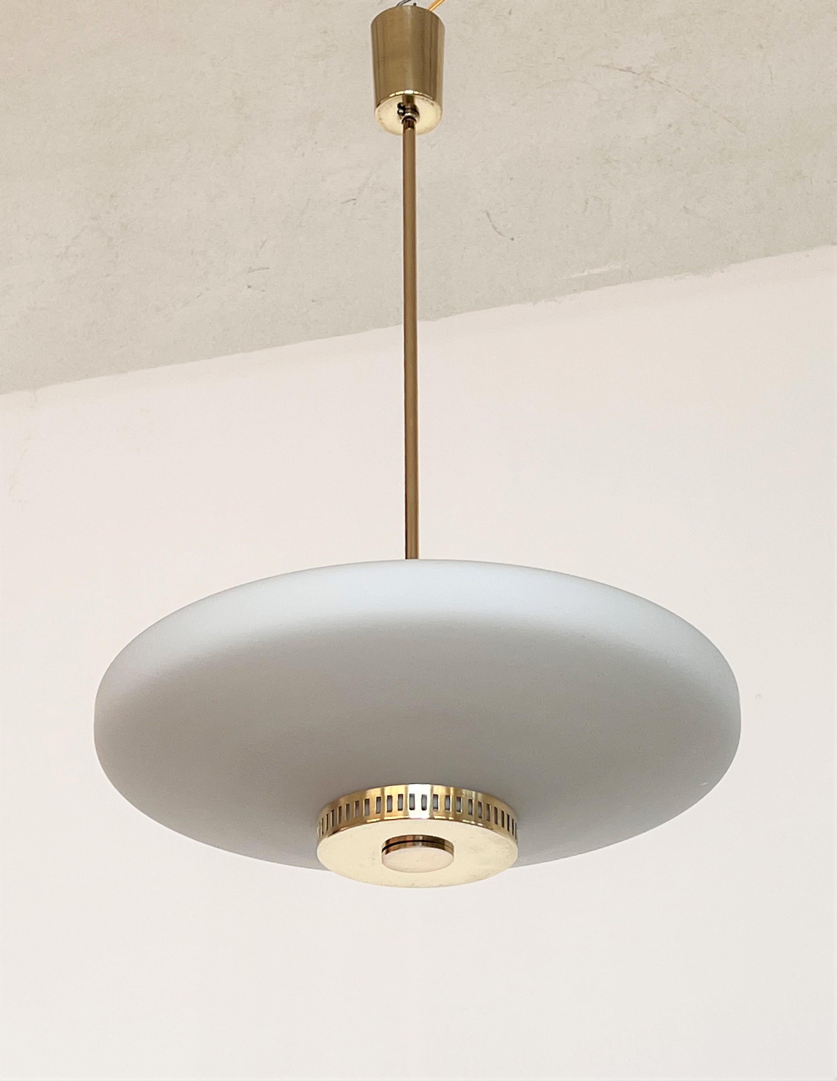 Gorgeous pendant light with stunning opaline glass Made in Italy by Stilnovo.
The pendant is fixed with a brass bar to ceiling and with its original ceiling rose in shiny brass .
Electric wire was renewed. 
The pendant light works with new standard