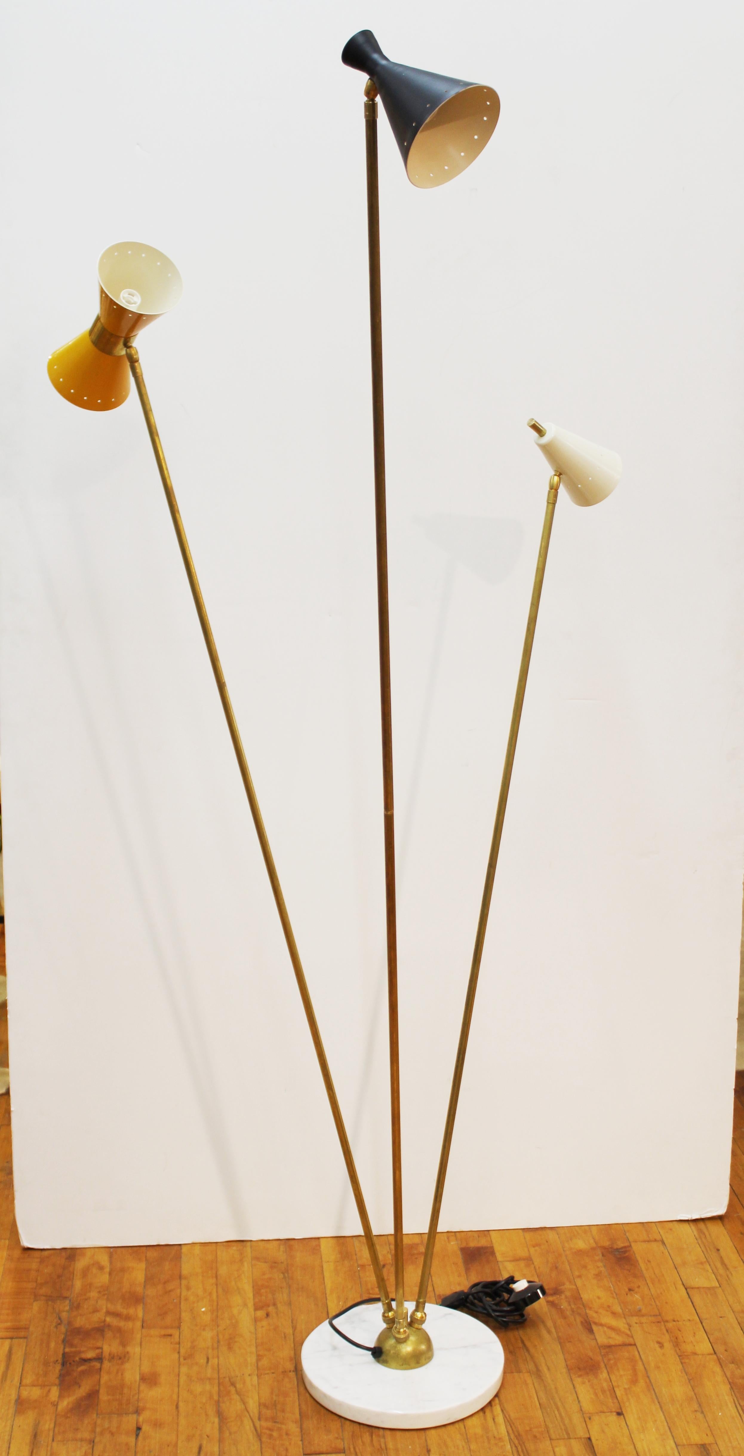 Italian midcentury style Stilnovo style floor lamp with round white marble base and 3 multi-color light stems and perforated enameled metal shades. In great vintage condition with age-appropriate wear.