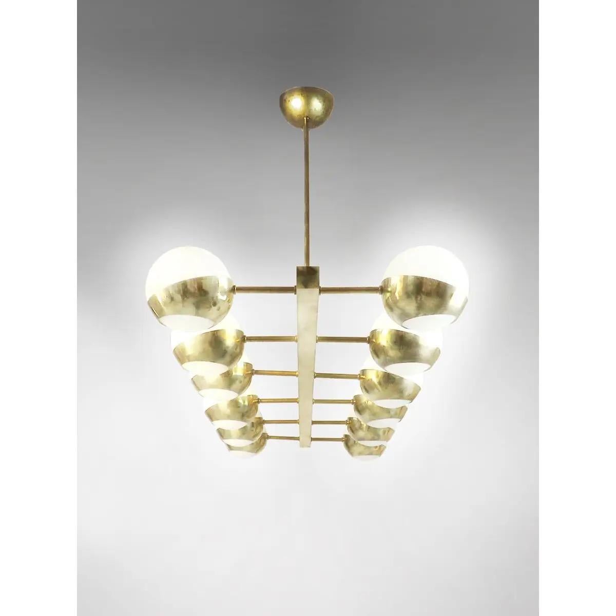Italian Mid Century style brass chandelier featuring 16 ball lights made of opaline glass of 12 cm diameter each, on a brass vintage treated structure. 

This Italian chandelier pays homage to the timeless and iconic style of the Italian