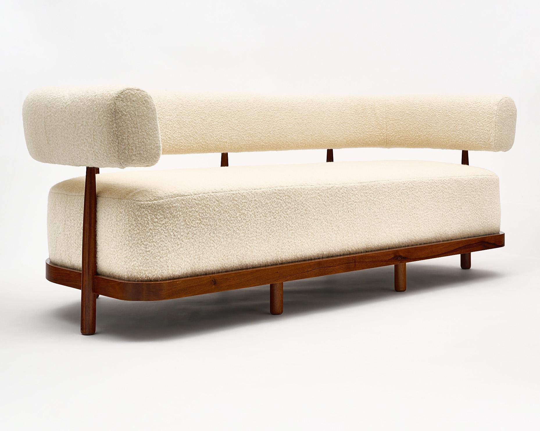 Pair of custom sofas from Italy made of strong and solid walnut frames with a “bouclé” wool blend upholstery. The pair is very deep and comfortable. We love the unique design and impact.
 