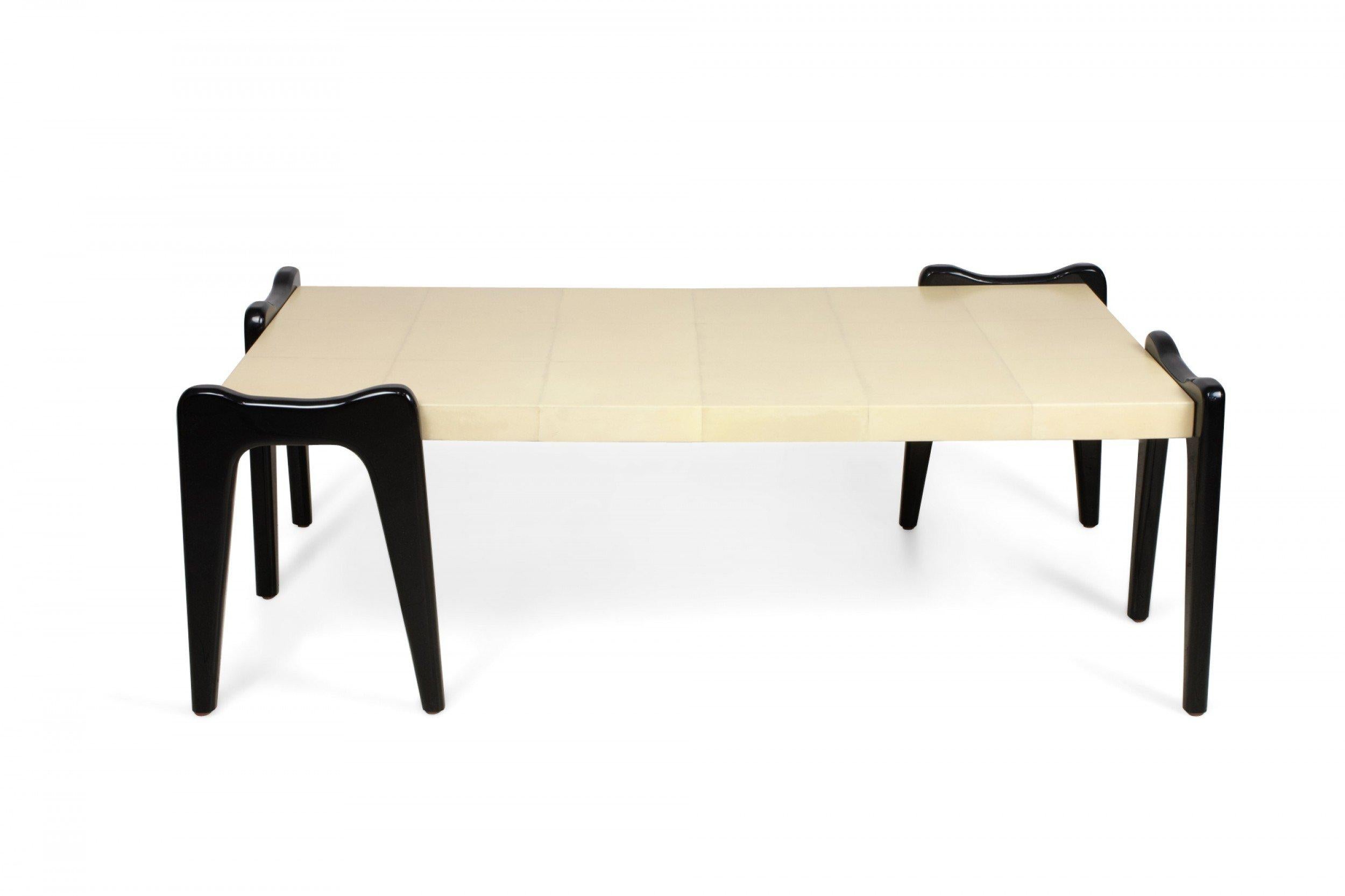 Italian 1940s-style (modern) rectangular coffee table with parchment veneer applied in squares of 3 x 6 rows and supported with 4 ebonized wood double leg forms (manner of ICO PARISI).
     