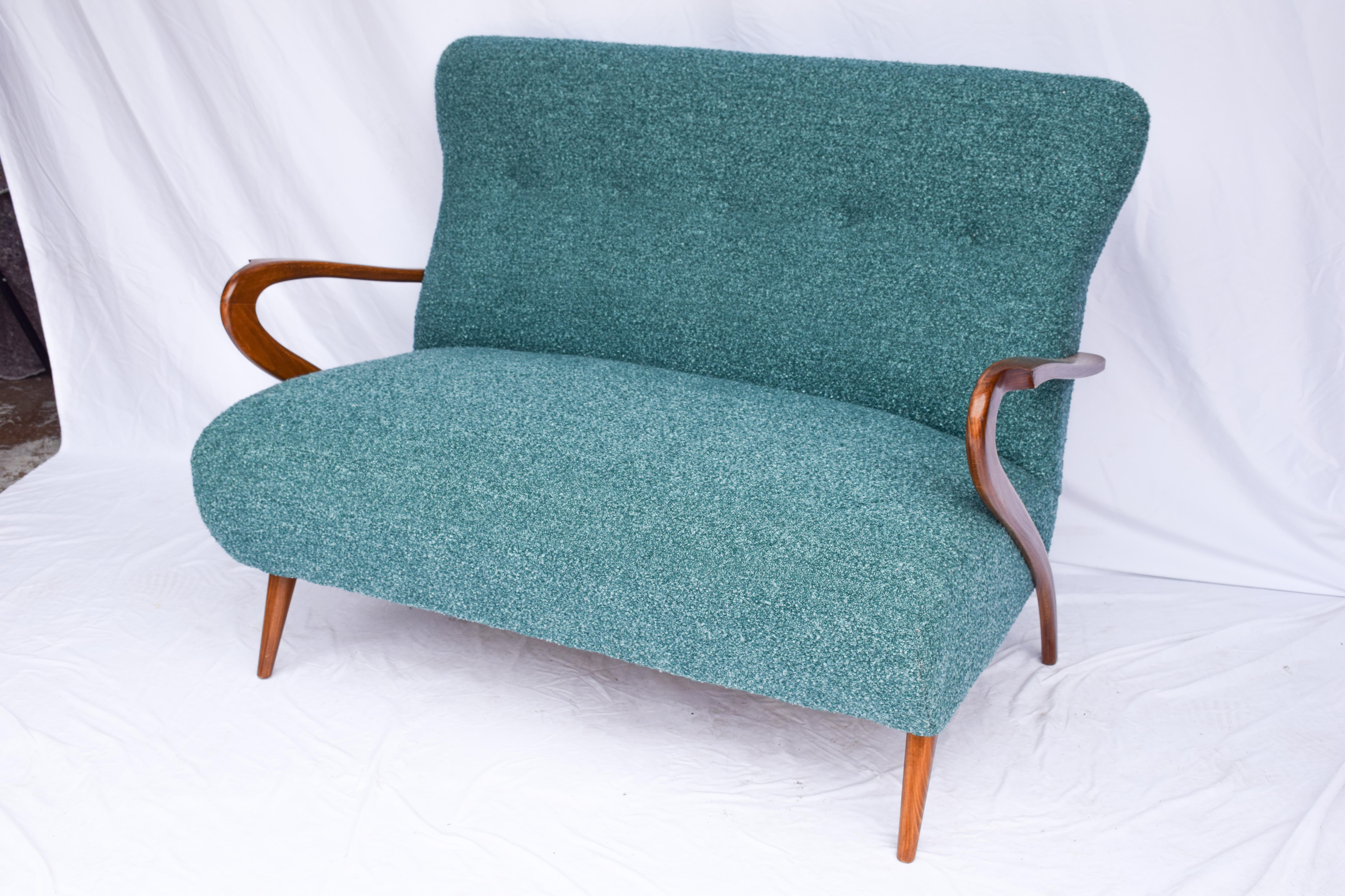 Explore the elegance of this Italian mid-century style settee. Upholstered in a Teal/Green/Blue nubby bouclé fabric. Discover the timeless sophistication and comfort of this stylish piece for your home or office. Found at an antique fair in the
