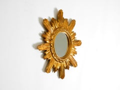 Italian Mid Century Sunburst wall mirror made of wood and resin, gold-plated