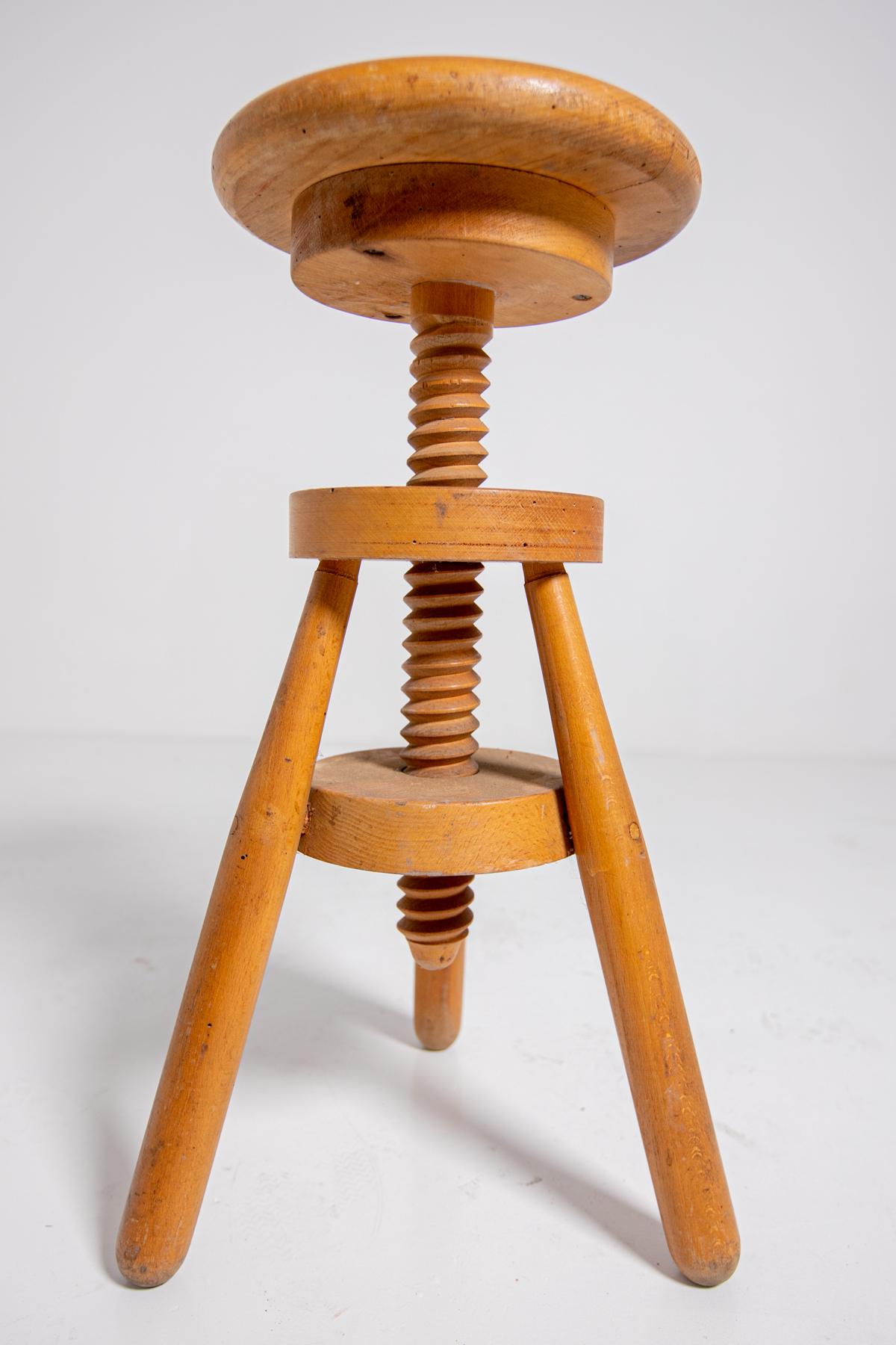Italian mid-century Industrial stool from the 1950s. The stool is totally made of wood. Through its central pivot worked in a vortex allows the ascent and descent of the stool at will. The stool is ideal for defining study corners or bedroom, or