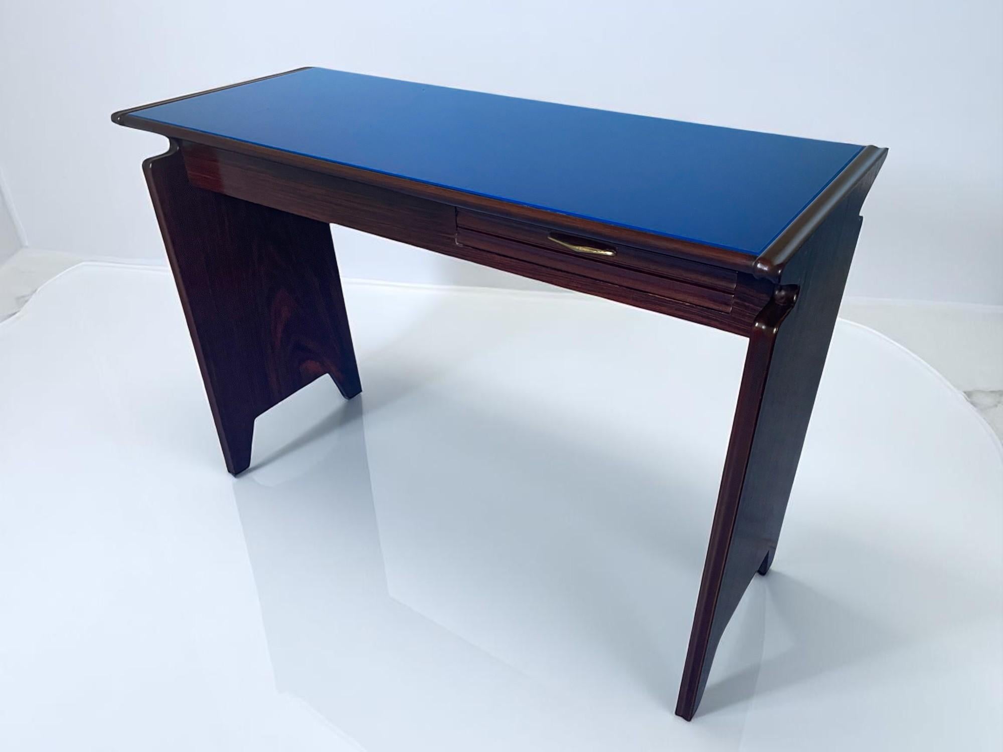 Stylish little Italian Table Desk attributed to Osvaldo Borsani 1950s, the top is characterised by the presence of a elegant blue glass top whose colour tone changes according to the light exposed, the original design of the sides with geometric