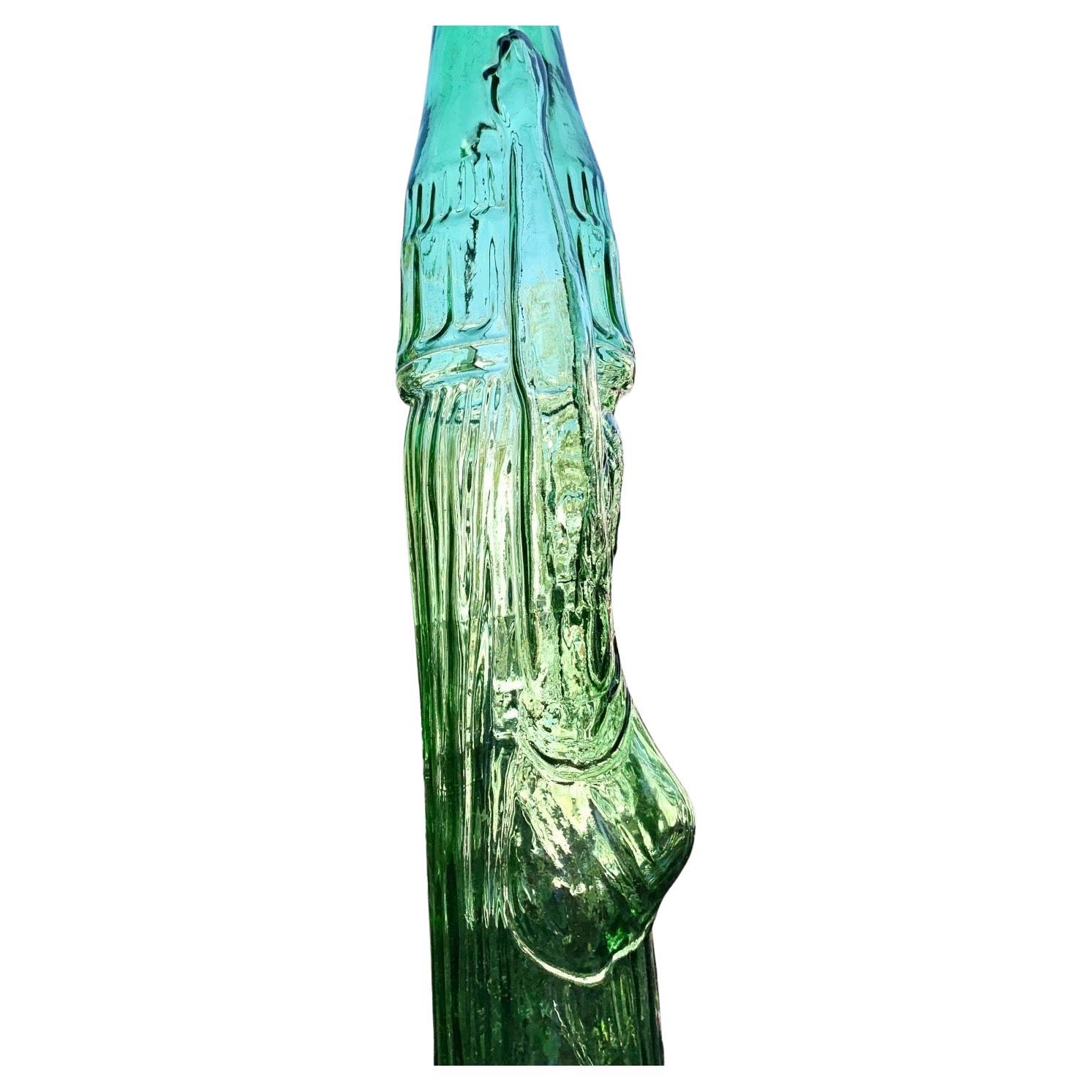 A vintage mid century tall glass wine bottle, limited addition from the 1970’s. 
The bottle with 3 liter volume. Green glass
shaped as beautiful Roman woman in classical dress holding a bottle on her head. The bottle issued by Casa Vinicola Cecchi &