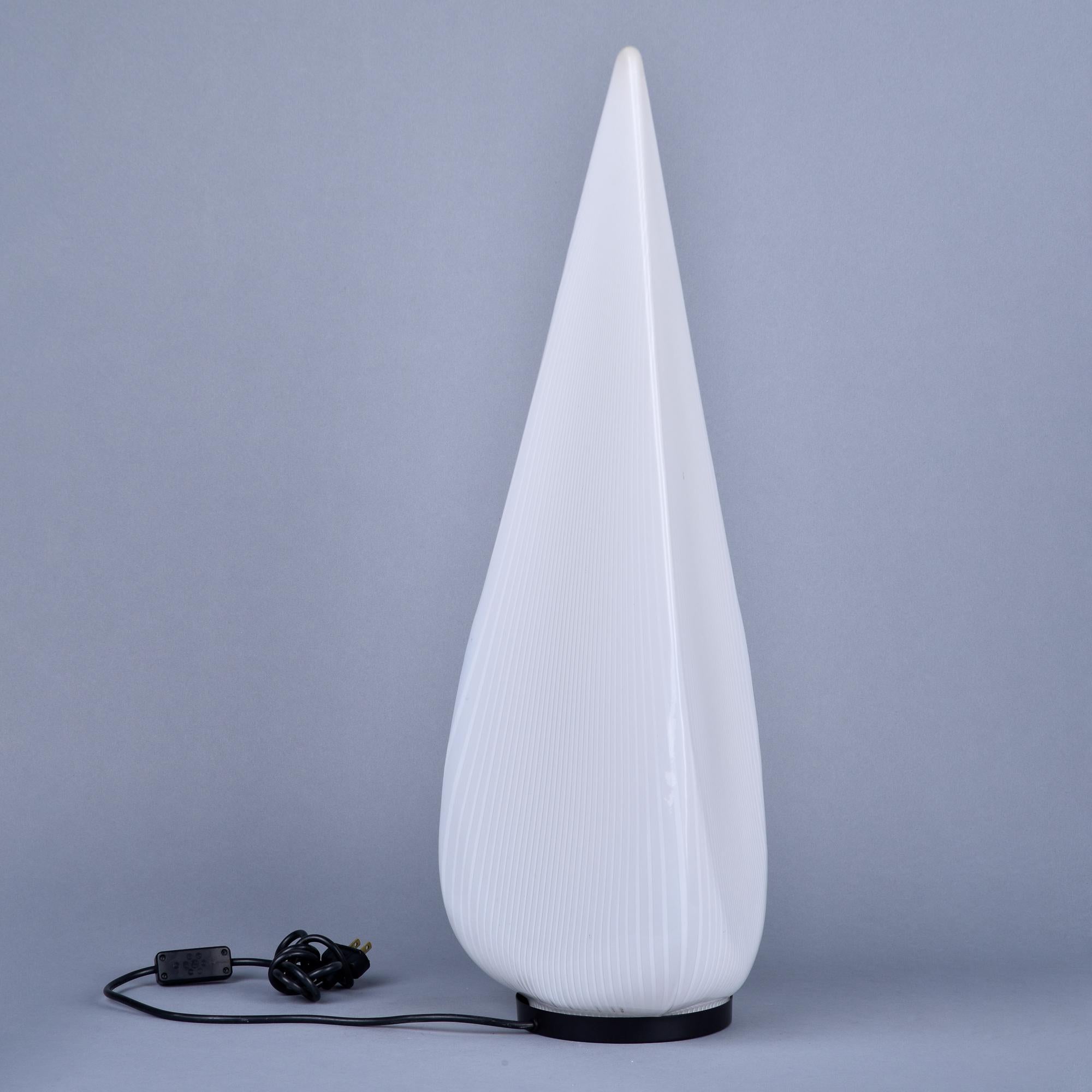 Found in Italy, this circa 1960s table lamp is just under 30” tall with a white tear-drop shaped shade of mouth blown glass. Shade has three sides, subtle white tonal striping and covers a single internal socket. New wiring for US electrical