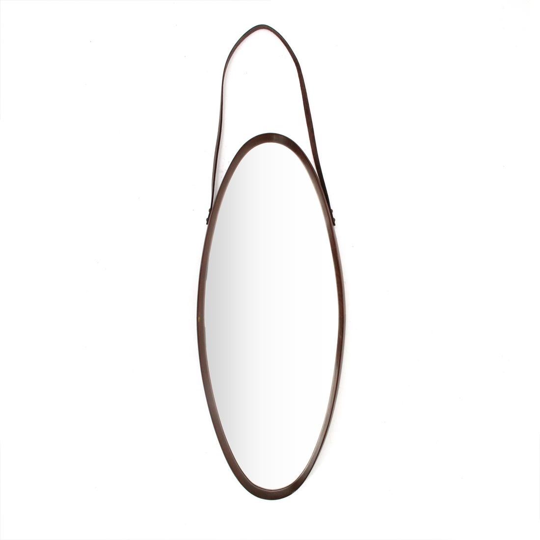 Italian manufacturing mirror produced in the 1960s.
Oval-shaped teak frame.
Mirror glass surface.
Leather cord.
Good general conditions, some signs due to normal use over time, lack of frame.

Dimensions: Length 34 cm, depth 4 cm, height 84 cm.