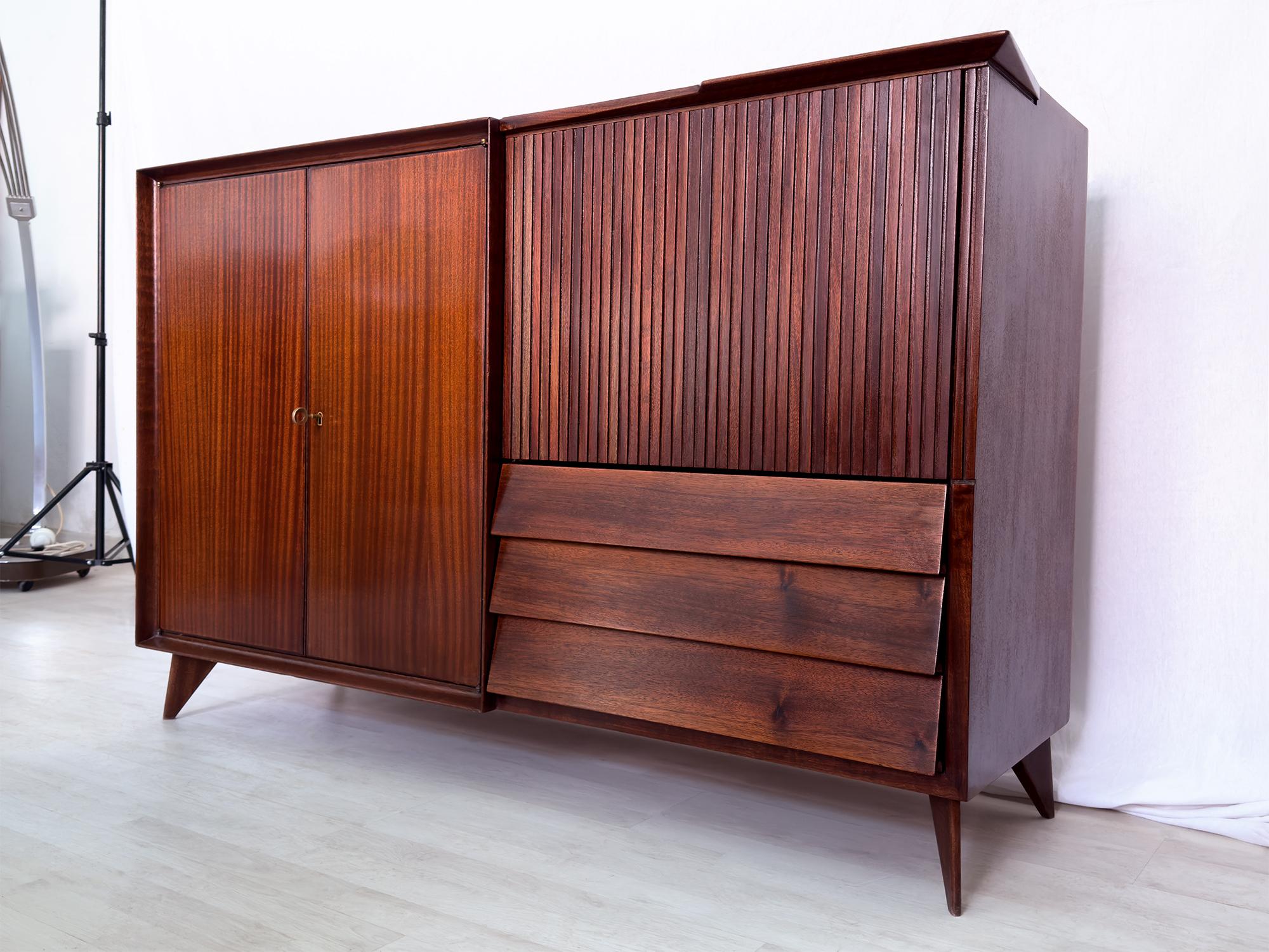 Stunning original Sideboard of the 1950s, attributable to the design of Vittorio Dassi, and crafted with a gorgeous material like as warm teakwood.

On left side two doors hidden a compartment with internal glass shelf, offering plenty of room for