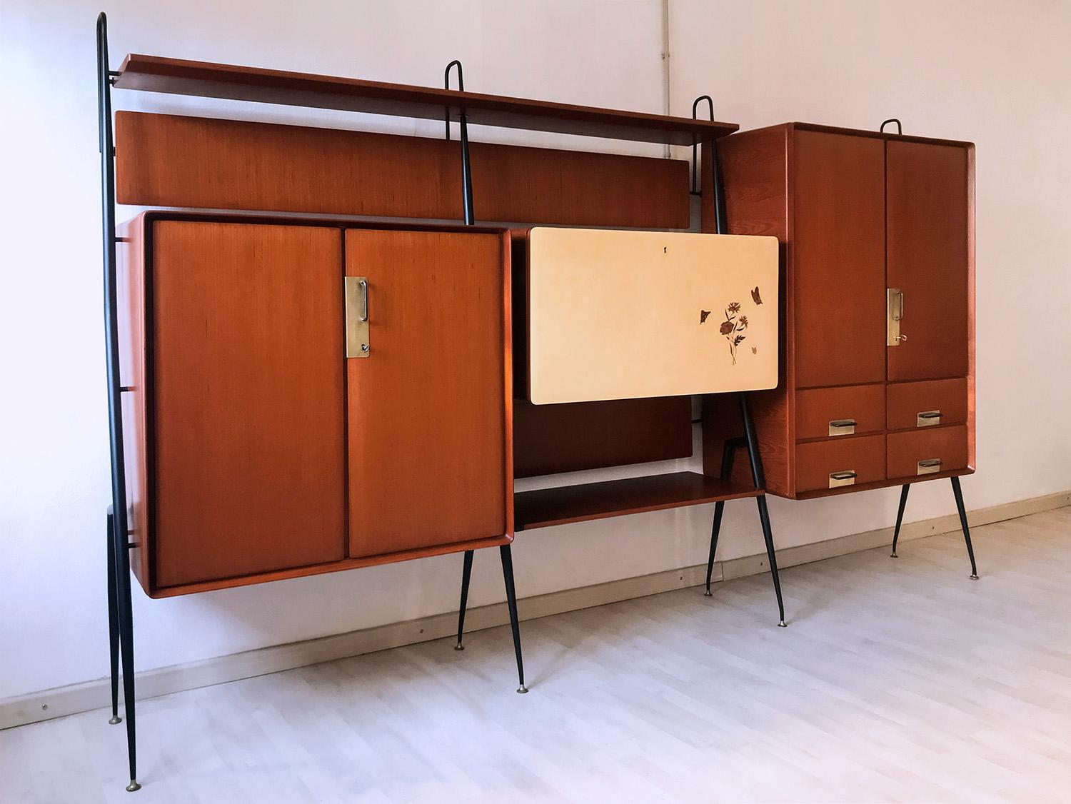 Stunning Italian living room teakwood Highboard designed and manufactured by Silvio Cavatorta in the 1950s.
The whole structure is supported by four black painted metal uprights and the two side cabinets are equipped with hinged doors and handles