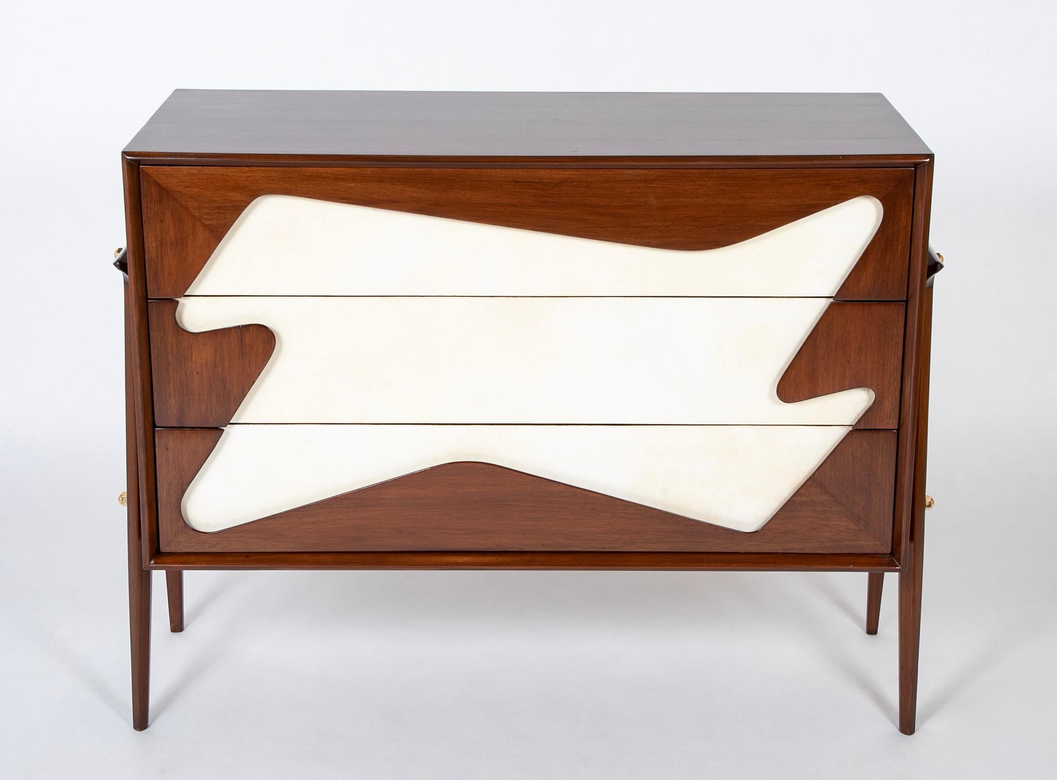 An Italian mid-century three drawer dresser in the manner of Gio Ponti's chests for the Royal Hotel.   The chest is walnut with free form parchment design to the front.  Circa 1955.