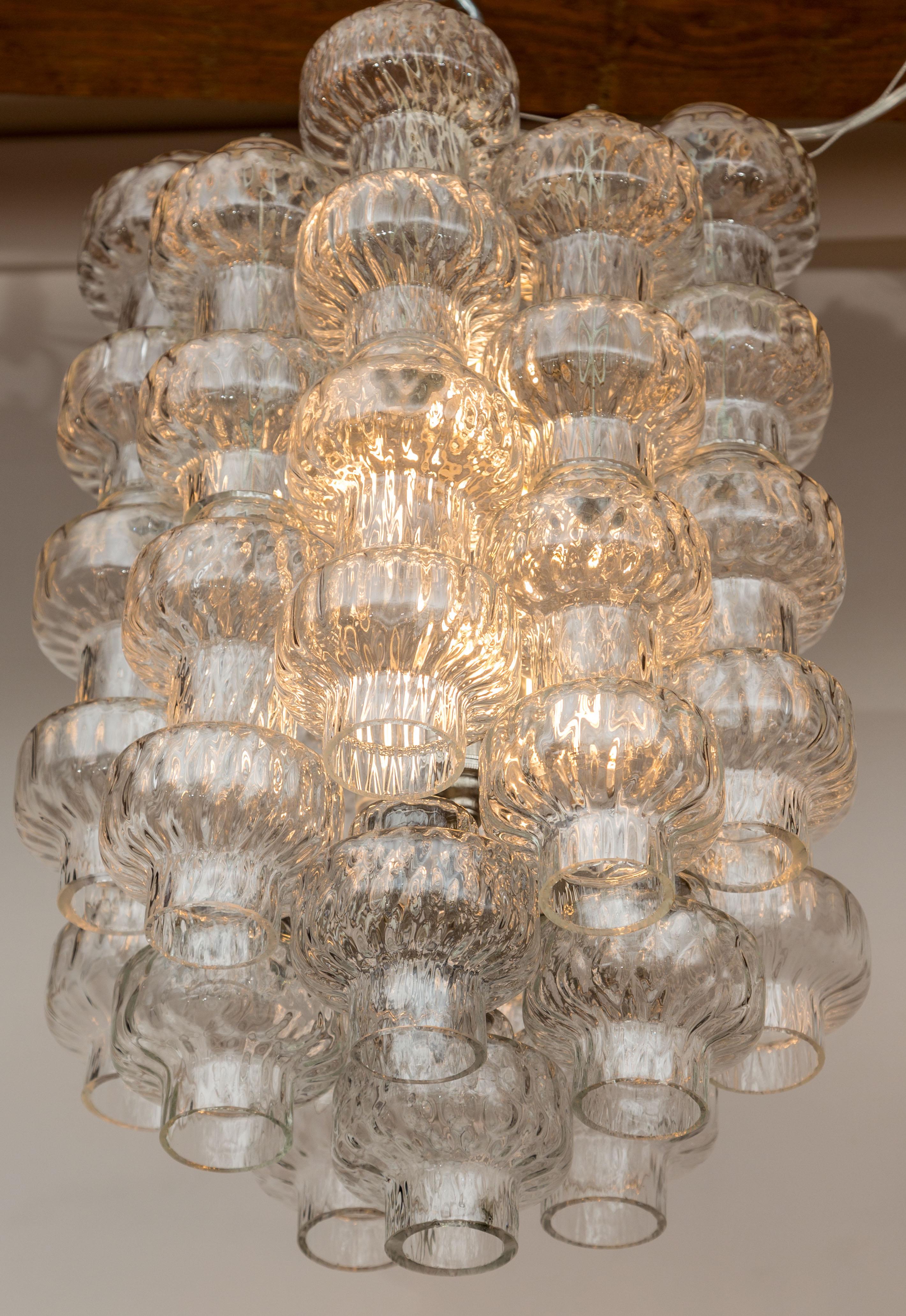 Lovely tiered and joined barbell-shaped crystal segments blown in two varying  ‘baloton’ styles.

Origin: Italy

Dating: 1960ca

Condition: Glass in excellent condition, fully rewired with 6 new UL approved nickeled candelabra sockets

Dimensions Of