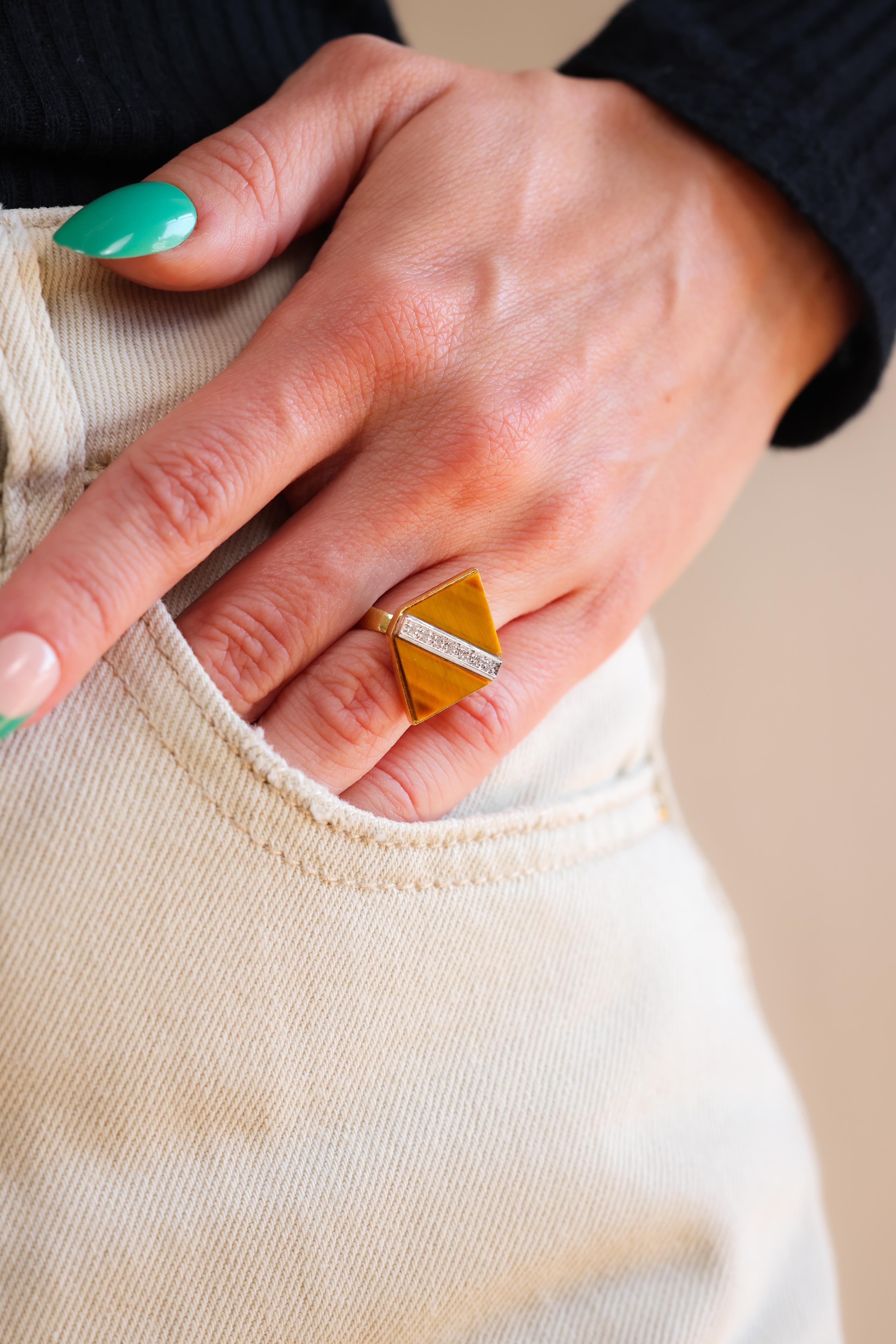 Center Stone: Tigers Eye
Accent Stone: 7 diamonds
Cut: Single
Weight: 0.05 carats 
Color: H-I
Clarity: VS
Metal: 18k yellow Gold 
Era: Mid-Century
Circa: 1960s
Hallmarks: Italy, makers mark and purity marks
Size: 5-3/4 and can be resized 
Gram