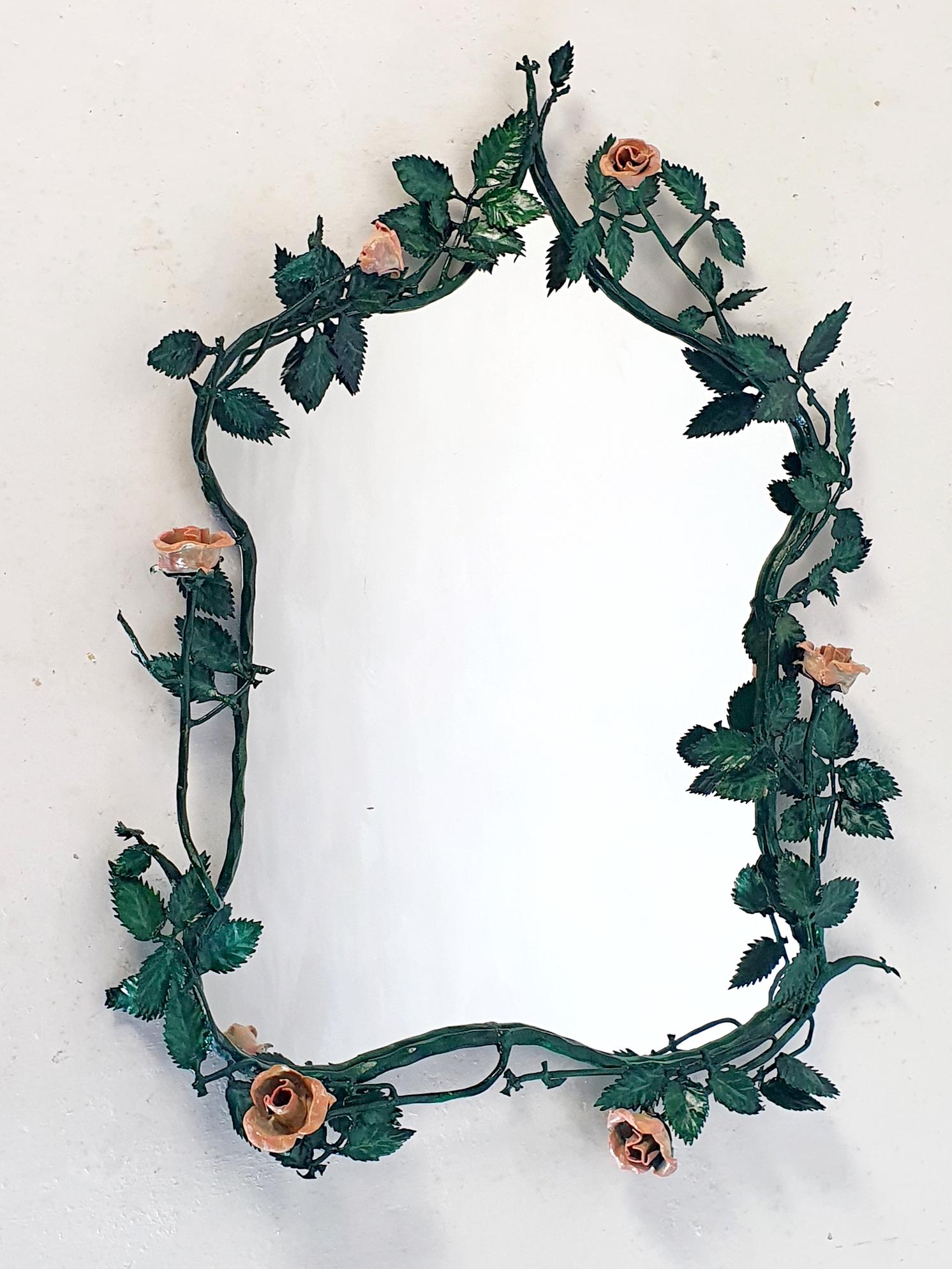 Italian tole wall mirror from the 1950's made from iron and hand painted in green and pink with a natural vintage patina. Colors may differ from the pics.