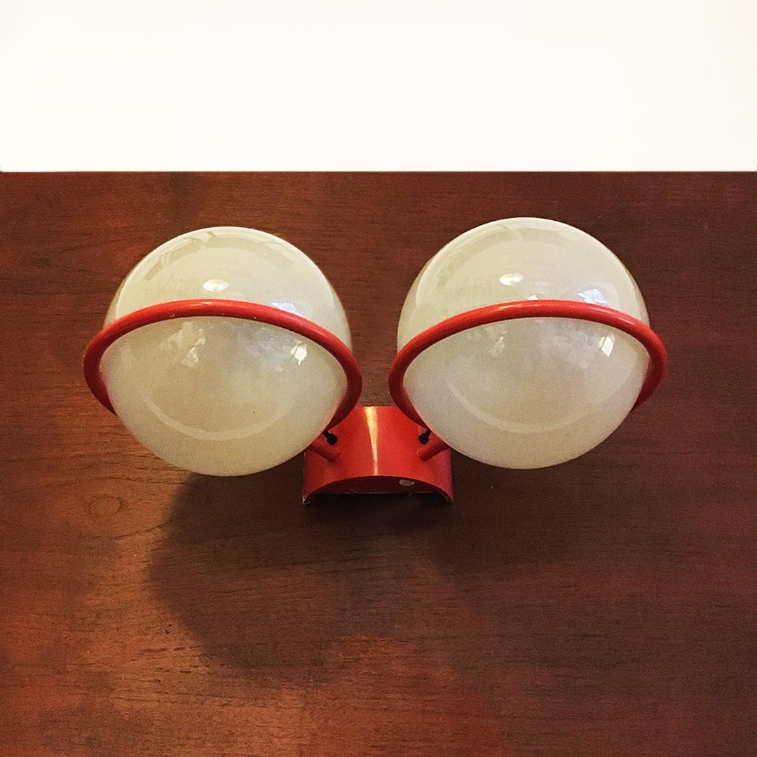 Italian mid-century two-light wall lamp by Gino Sarfatti for Arteluce, 1960s
Two-light wall lamp with red metal rod structure on which two shiny glass spheres are placed.
Designed by Gino Sarfatti for Arteluce, 1960s.

Brand present, good