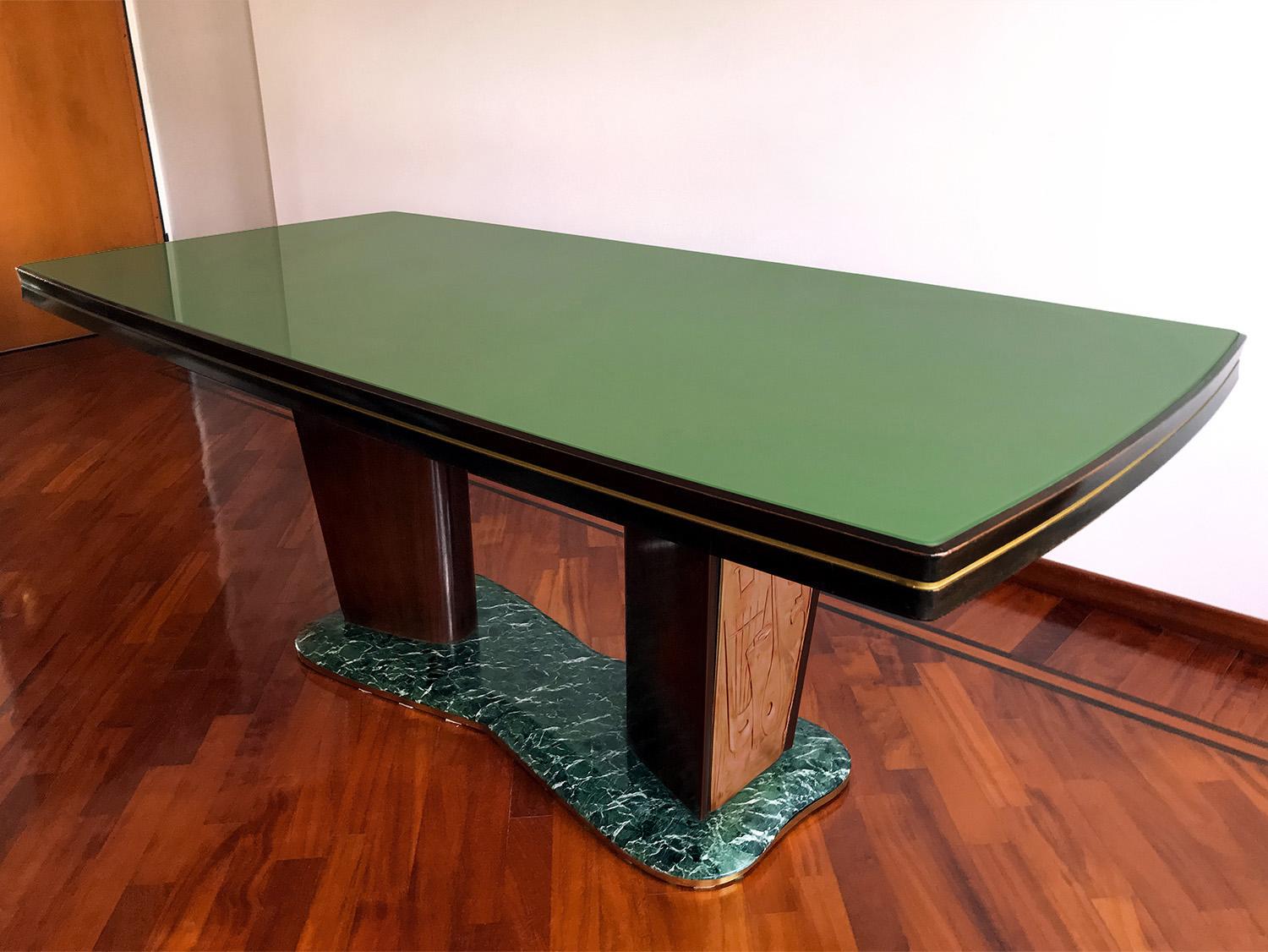 For your consideration this elegant dining table in Art Deco style, designed by Vittorio Dassi in the 1950s.
The top-table has a glass back-treated with green colored paper and is supported by two big legs fixed on a basement made of precious