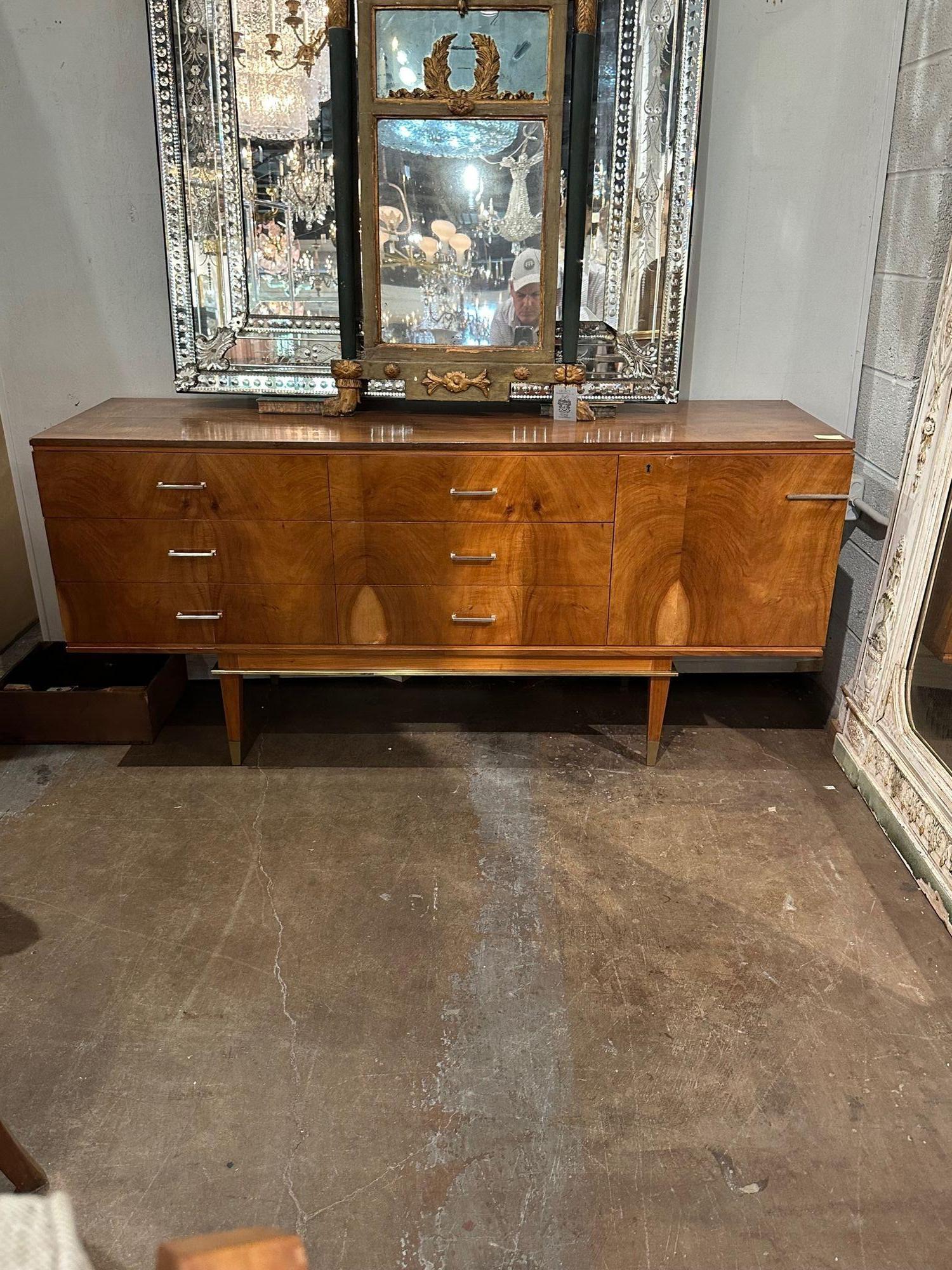 Handsome Italian Mid-Century Modern walnut and brass dresser. Circa 1960. Adds warmth and charm to any room!