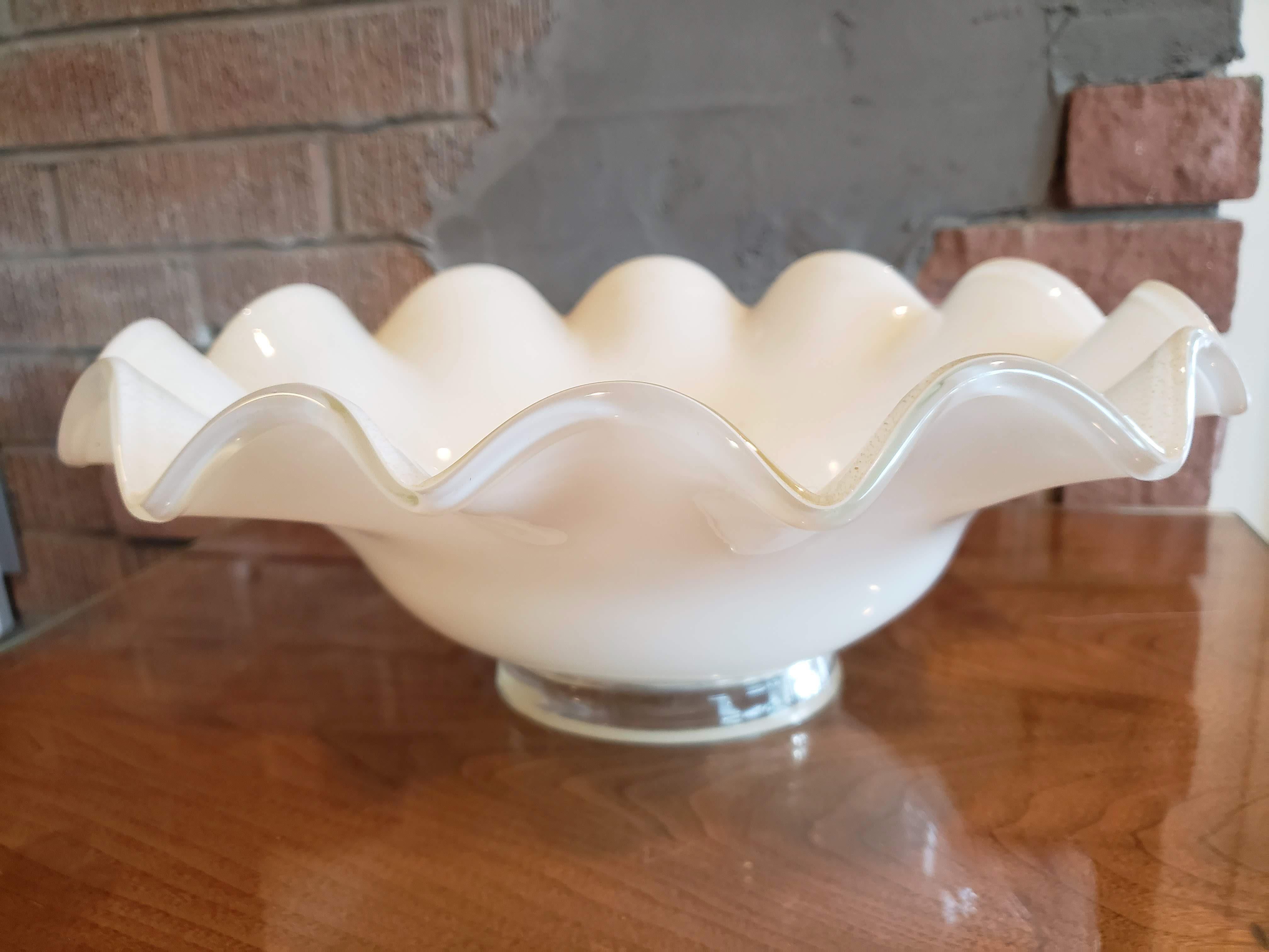 Mid-century hand blown glass bowl featuring white glass with 24 karat gold flecks. Scalloped edge and hand made details make this a wonderful centerpiece. Italian, 1960s.