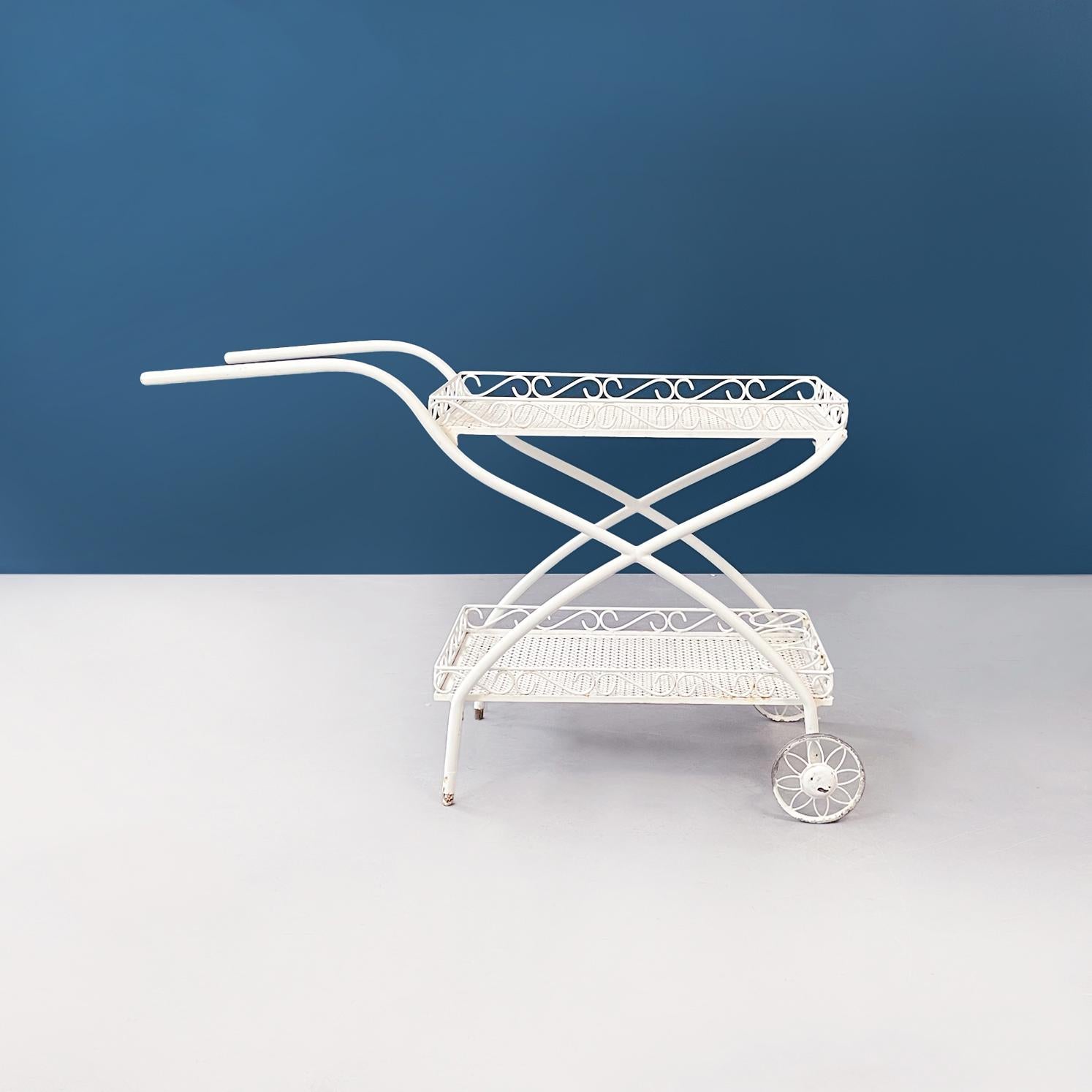 Italian mid-century white iron garden cart openwork with curls, 1960s
Outdoor cart in white painted iron. The cart has two compartments, with floral-shaped perforations, and finely worked edges with curls. On the lower shelf there are 3 bottle