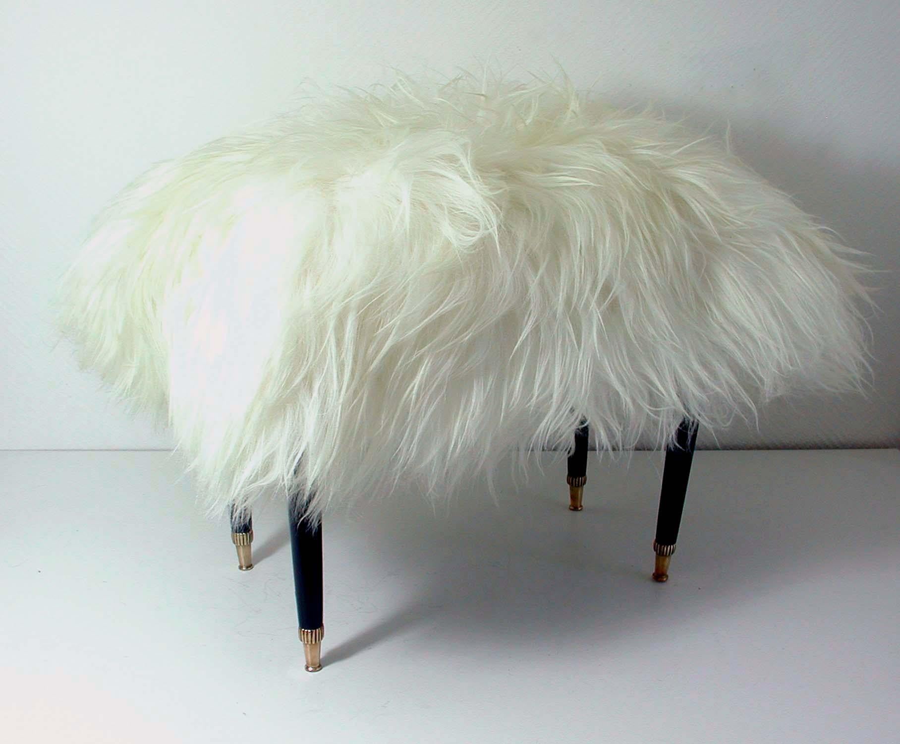 This midcentury stool was made in Italy in the 1950s. It has got 4 black lacquered legs with brass tips and a real white Iceland lamb fur seat. It has been refurbished: the wooden legs relacquered and the seat reupholstered. 

The fur is new and