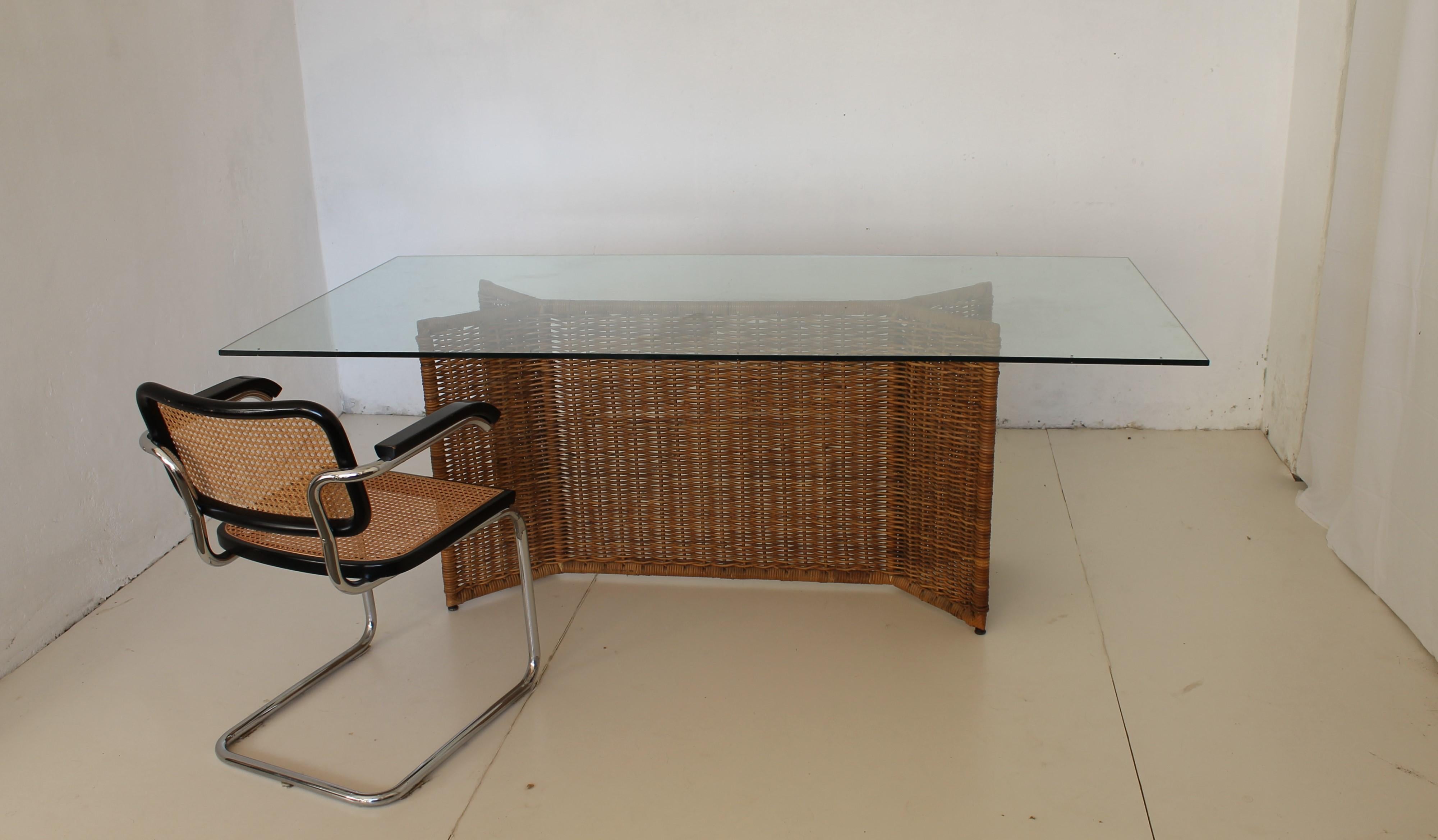 Italian Mid-Century Wicker and Tempered Glass Table, circa 1965.

A large rectangle dining table that will accommodate all your guests. A stable, powder-coated metal frame is braided with rattan and a transparent table top made of tempered glass.