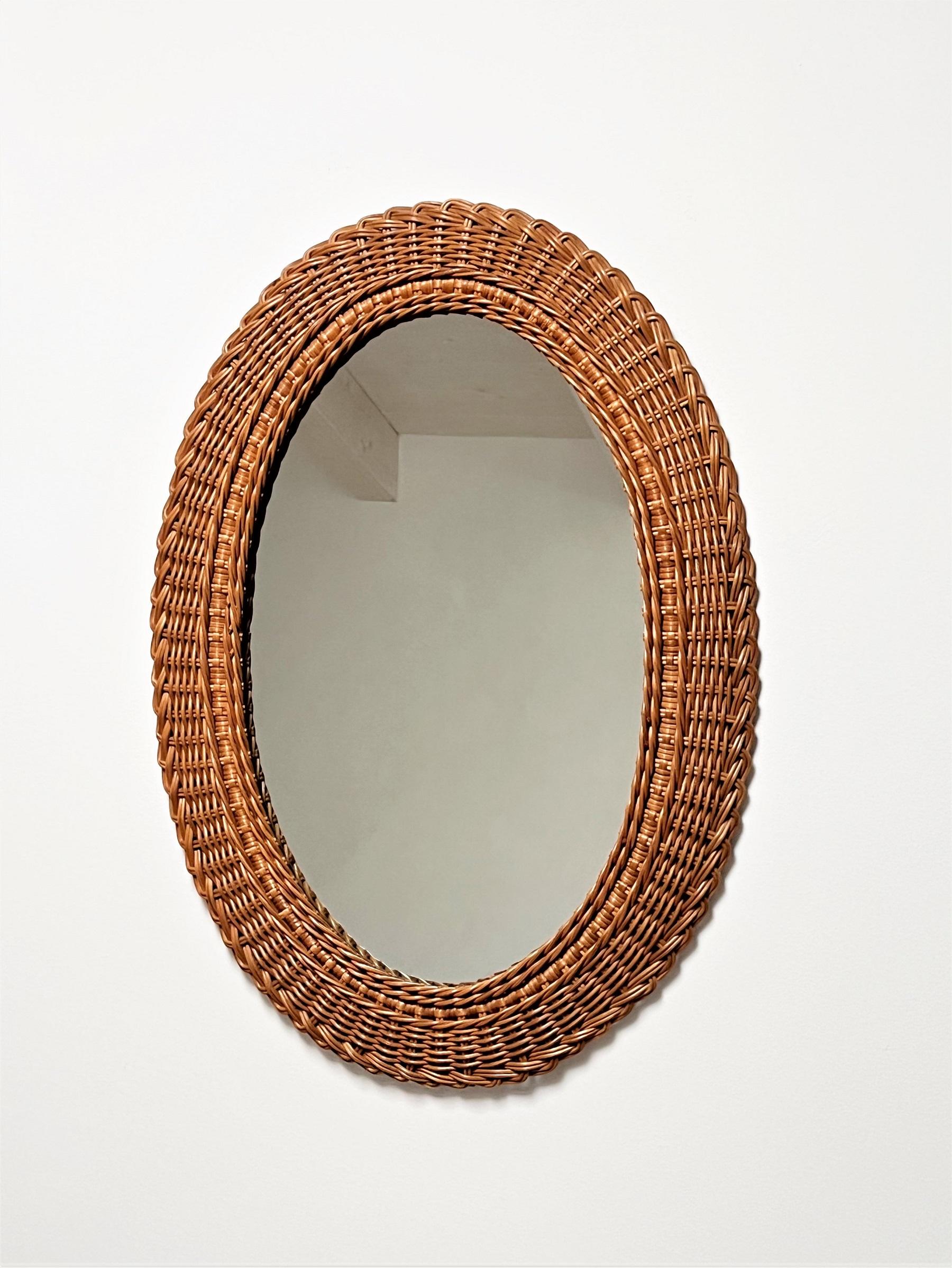 Beautiful wall mirror made in Italy during the 1970s.
The 9 cm (3,5inch) large mirror frame is made interely of hand-crafted woven wicker.
The mirror glass and the frame are in very good condition.
At the backside is a hook for wall hanging.


