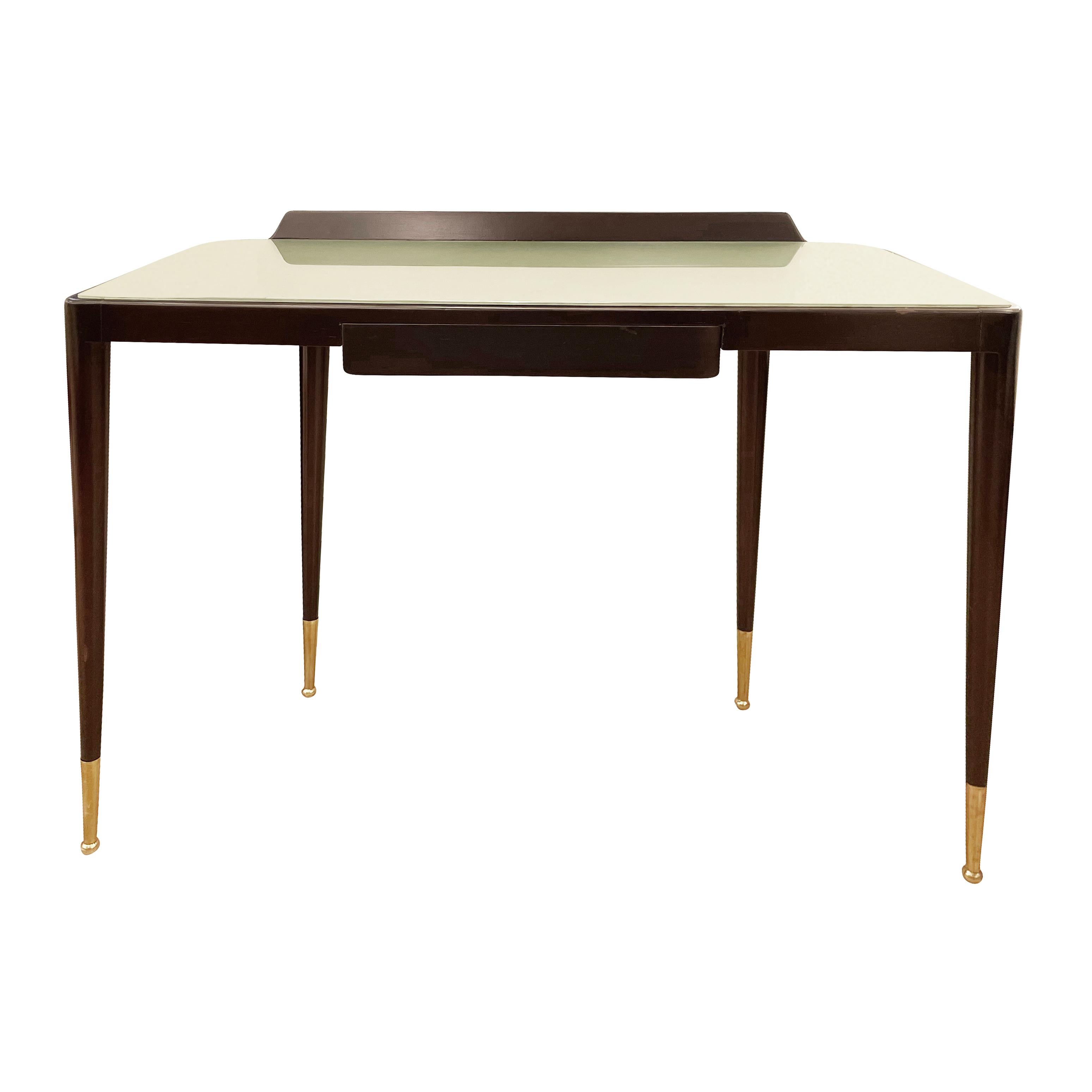 Sleek Italian Mid-Century wood console by Gio Ponti with a light green-gray glass top and brass leg caps. Has one central drawer and is finished in the back allowing it to be a freestanding piece.

Condition: Excellent vintage condition, minor wear